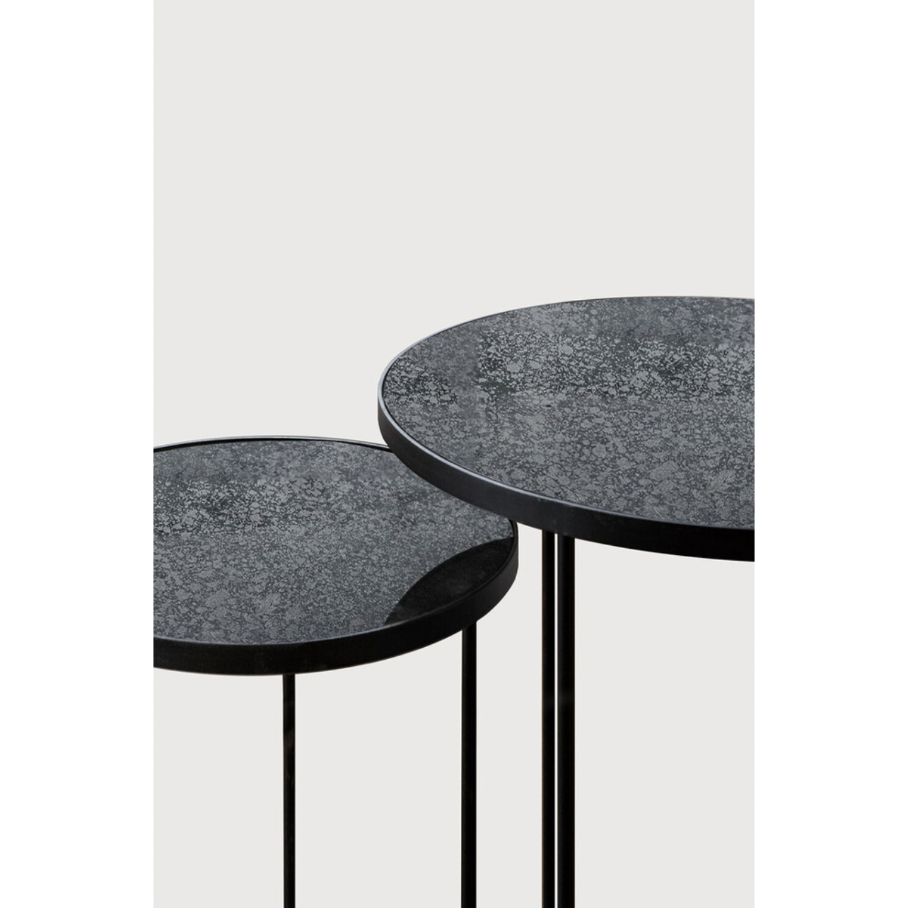 Featuring a heavy aged mirror surface, this Charcoal Nesting Side Table Set brings a unique look to any space. Place beside the sofa, sitting next to your bed, or as a complementary piece to a work of art, its adaptability offers many possibilities.  Dimensions: 22.5"w x 22.5"d x 27.5"h   Material: Mirror
