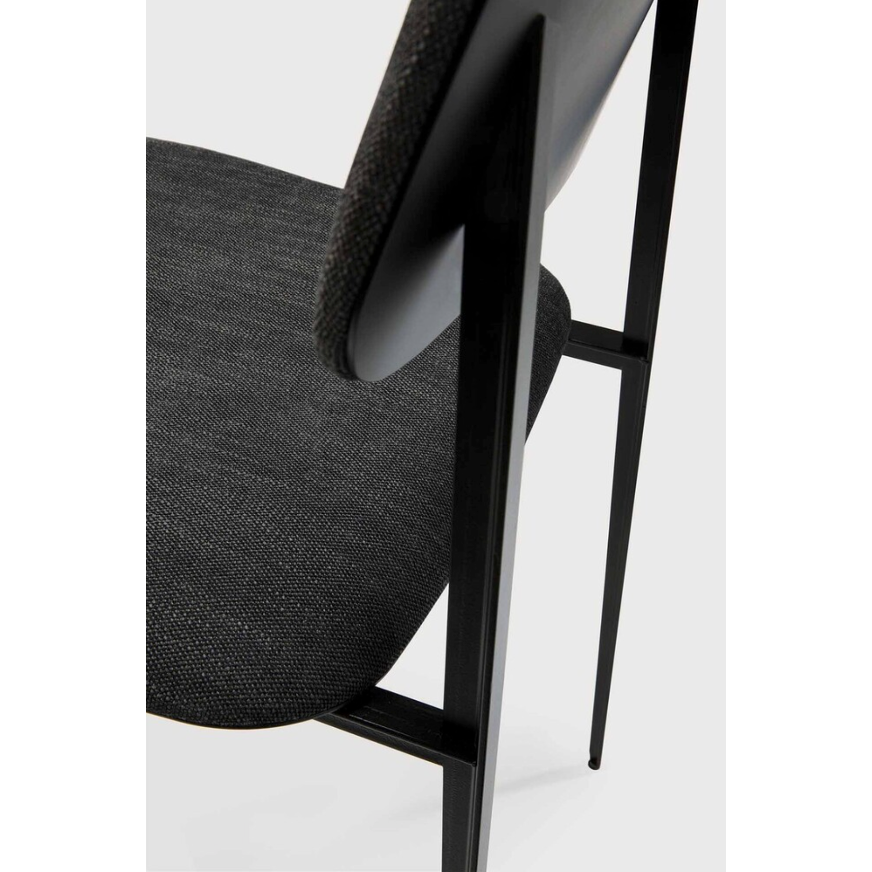 This DC Dining Chair is beautiful, minimalistic metal silhouette that would add an air of elegance to your dining table or kitchen. We love the details of the angled metal and the simplicity of this stunning chair.  Dimensions: 17"w x 19"d x 32.5"h  Weight: 19 lbs  Seat Height: 20"  Material: Metal Finish: Dark Grey Upholstery