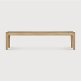 This Oak Bok Bench features an airy shape with rock-solid construction,  making this piece a timeless and remarkable design to enjoy for years to come. Pair with a dining table or stand-alone against a wall, hallway, or end of the bed!  Material: Oak Finish: Oiled