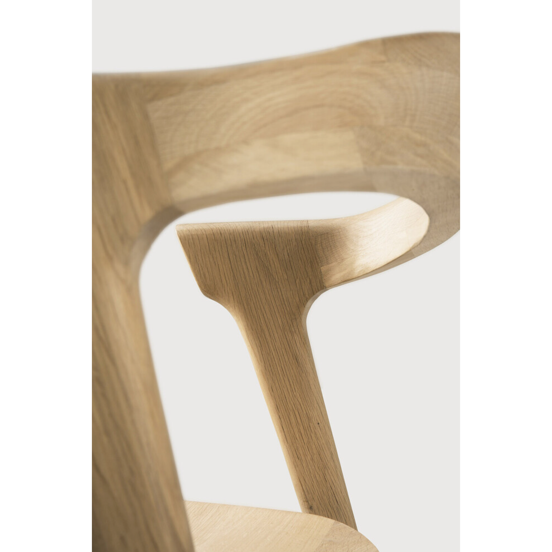 This Oak Bok Dining Chair features an airy shape with rock-solid construction,  making this piece a timeless and remarkable design to enjoy for years to come. Pair with a dining table or stand-alone against a wall, hallway, or end of the bed! Designed by Alain can Havre  Dimensions: 20"w x 21.5"d x 30"h  Weight: 20 lbs  Seat Height: 18"  Material: Oak, 100% solid wood Finish: Oiled