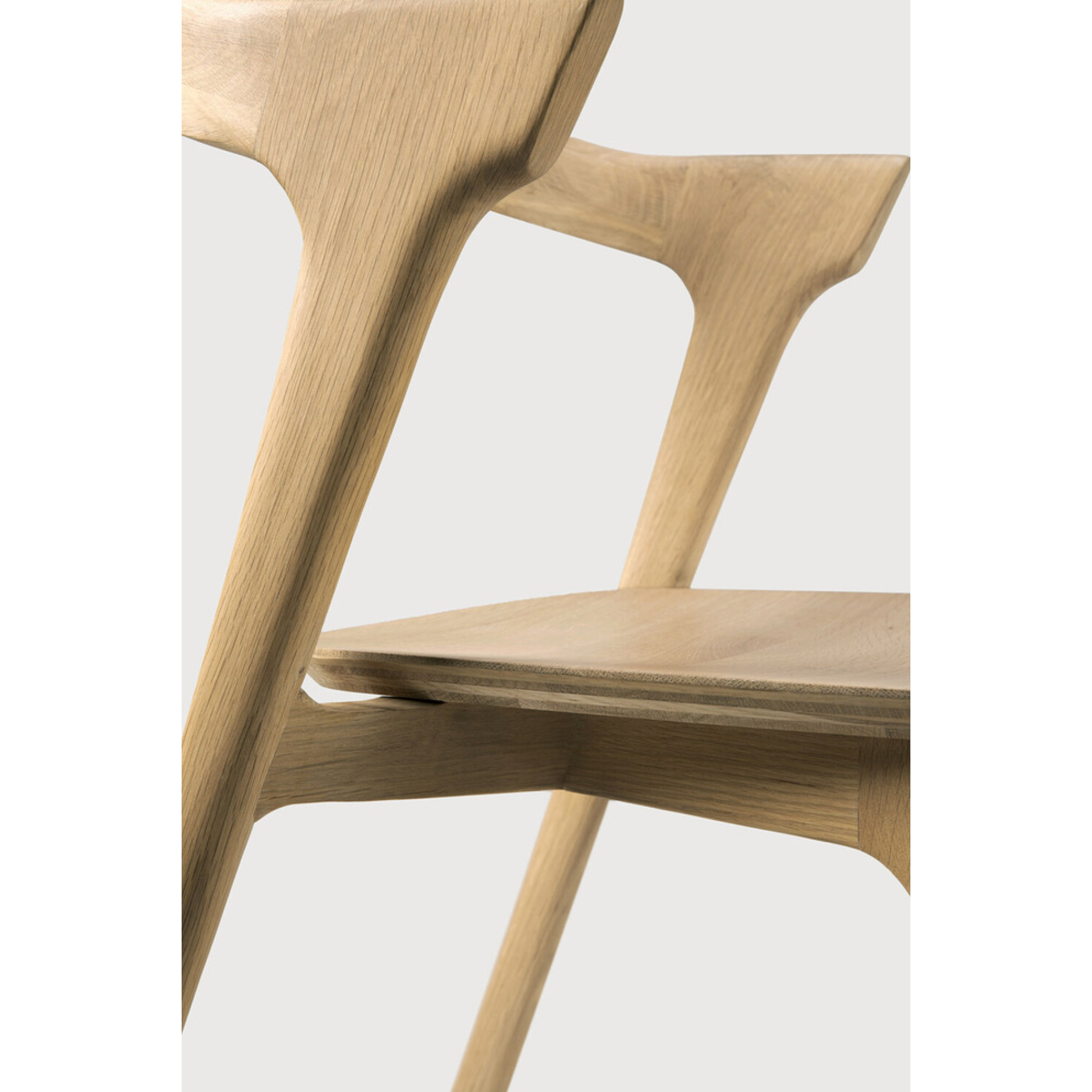 This Oak Bok Dining Chair features an airy shape with rock-solid construction,  making this piece a timeless and remarkable design to enjoy for years to come. Pair with a dining table or stand-alone against a wall, hallway, or end of the bed! Designed by Alain can Havre  Dimensions: 20"w x 21.5"d x 30"h  Weight: 20 lbs  Seat Height: 18"  Material: Oak, 100% solid wood Finish: Oiled