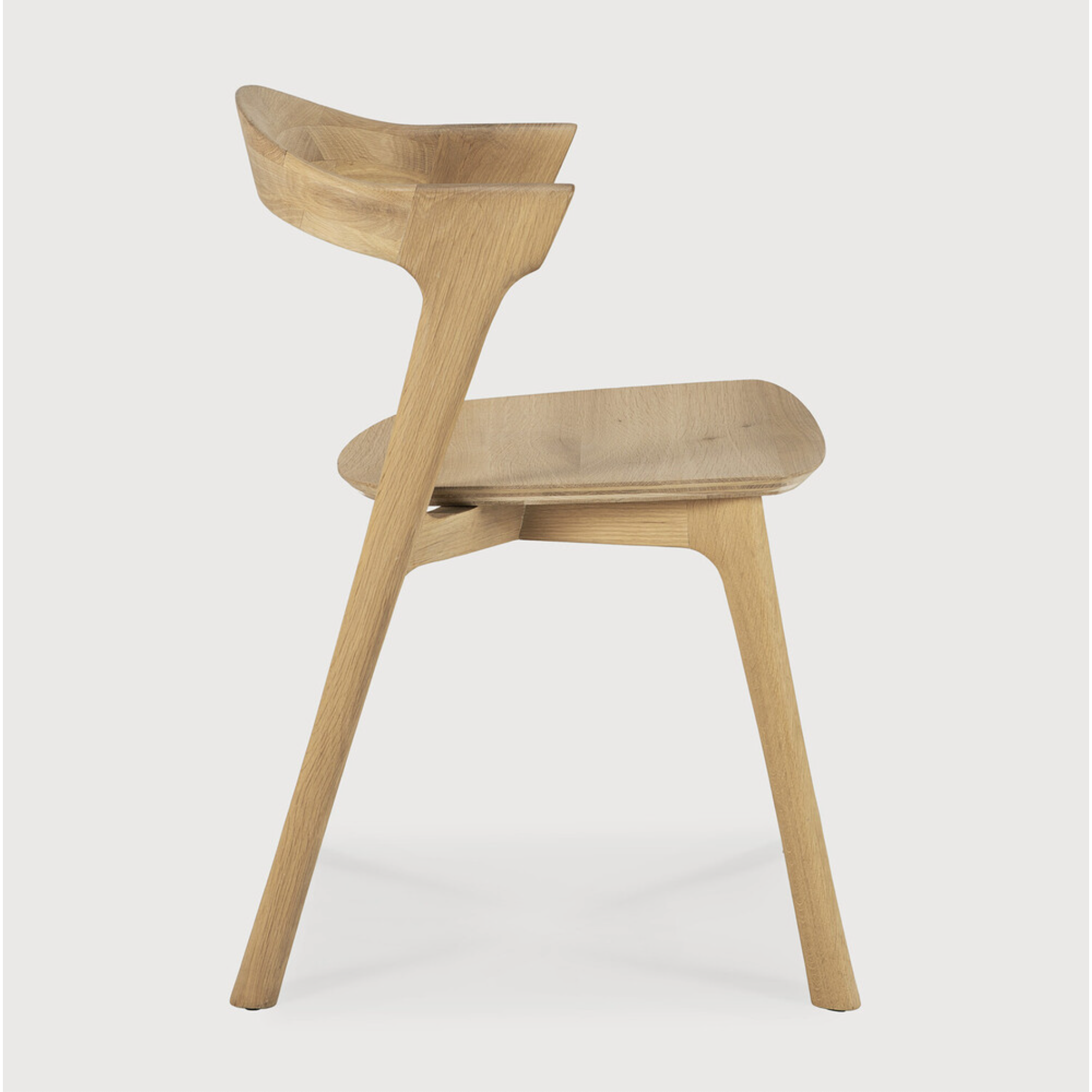 This Oak Bok Dining Chair features an airy shape with rock-solid construction,  making this piece a timeless and remarkable design to enjoy for years to come. Pair with a dining table or stand-alone against a wall, hallway, or end of the bed! Designed by Alain can Havre  Dimensions: 20"w x 21.5"d x 30"h  Weight: 20 lbs  Seat Height: 18"  Material: Oak, 100% solid wood Finish: Oiled