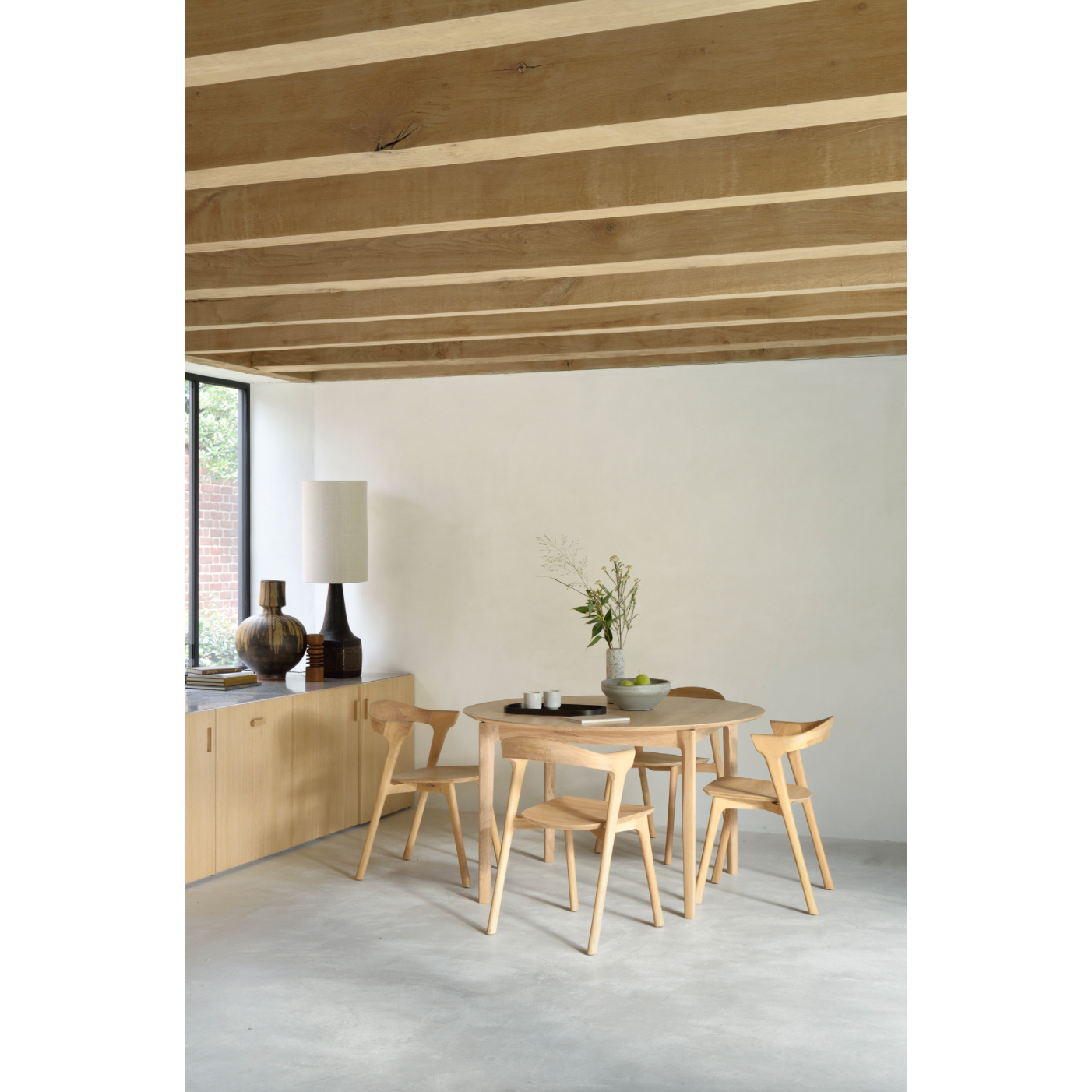 This Oak Bok Round Extendable Dining Table offers the perfect solution for adaptable dining within a smaller space. The iconic airy shape and solid construction make for a timeless design to enjoy for years to come.  Material: Oak, 100% Solid Wood Finish: Oiled