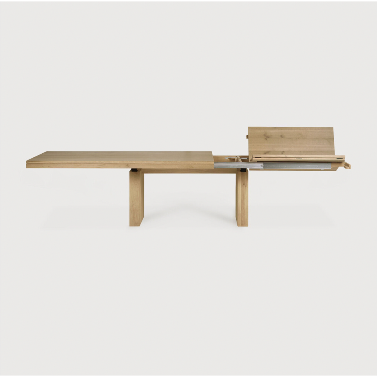 We love the solid look and pure lines of this Oak Double Extendable Dining Table.   Although the table looks heavy, it can very easily be extended single-handedly. It takes a few steps and no more than seconds to make space for whatever will be happening next in your home!  Material: Oak, 100% Solid Wood Finish: Oak  