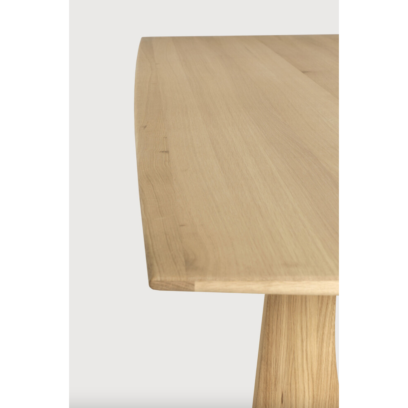 With enriched shapes and unexpected details, this Oak Geometric Dining Table is a statement item. Luxury comes with its length, which is offset by softened edges and natural lines -- perfect for any dining room or workspace.   Material: Oak, 100% Solid Wood Finish: Oiled