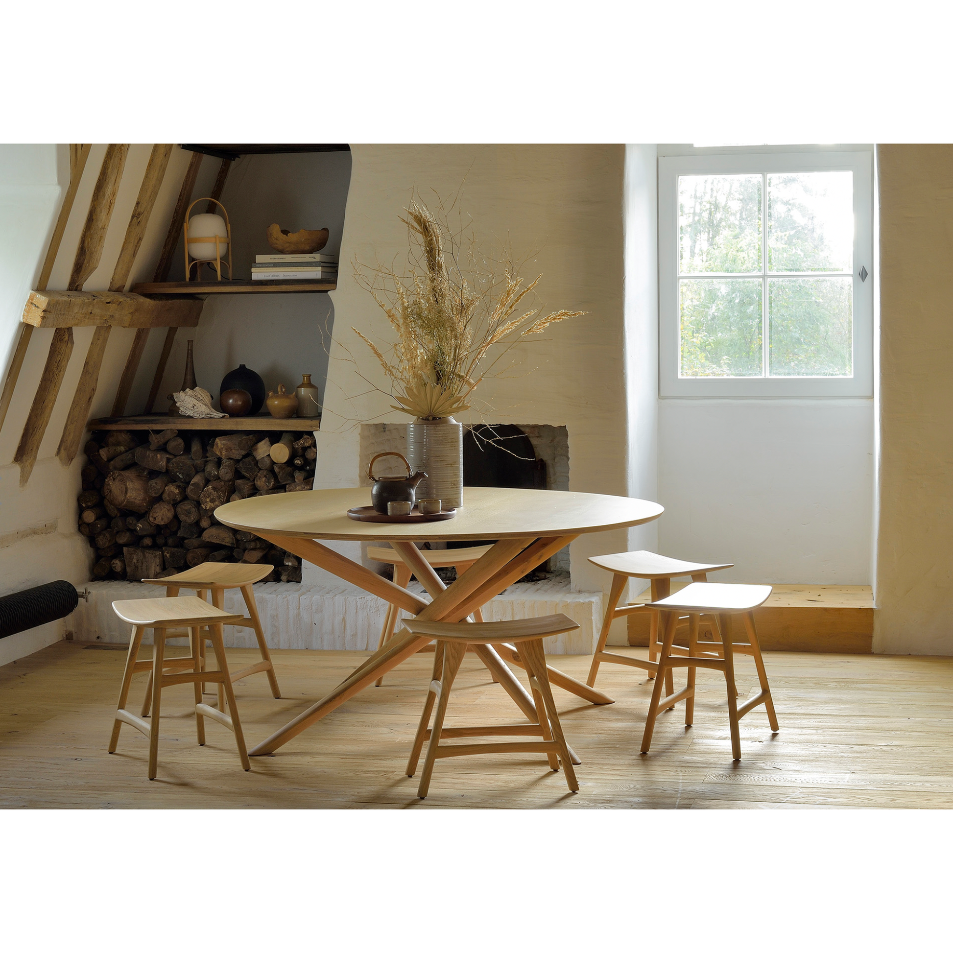 We love the sculptural character of this Oak Mikado Dining Table - Round. The legs interlock like a well-thought-out puzzle, making it easier to interact with your guests and allows you to converse with your family and friends for years to come!  Designed by Alain van Havre  Material: Oak, 100% Solid Wood Finish: Oiled