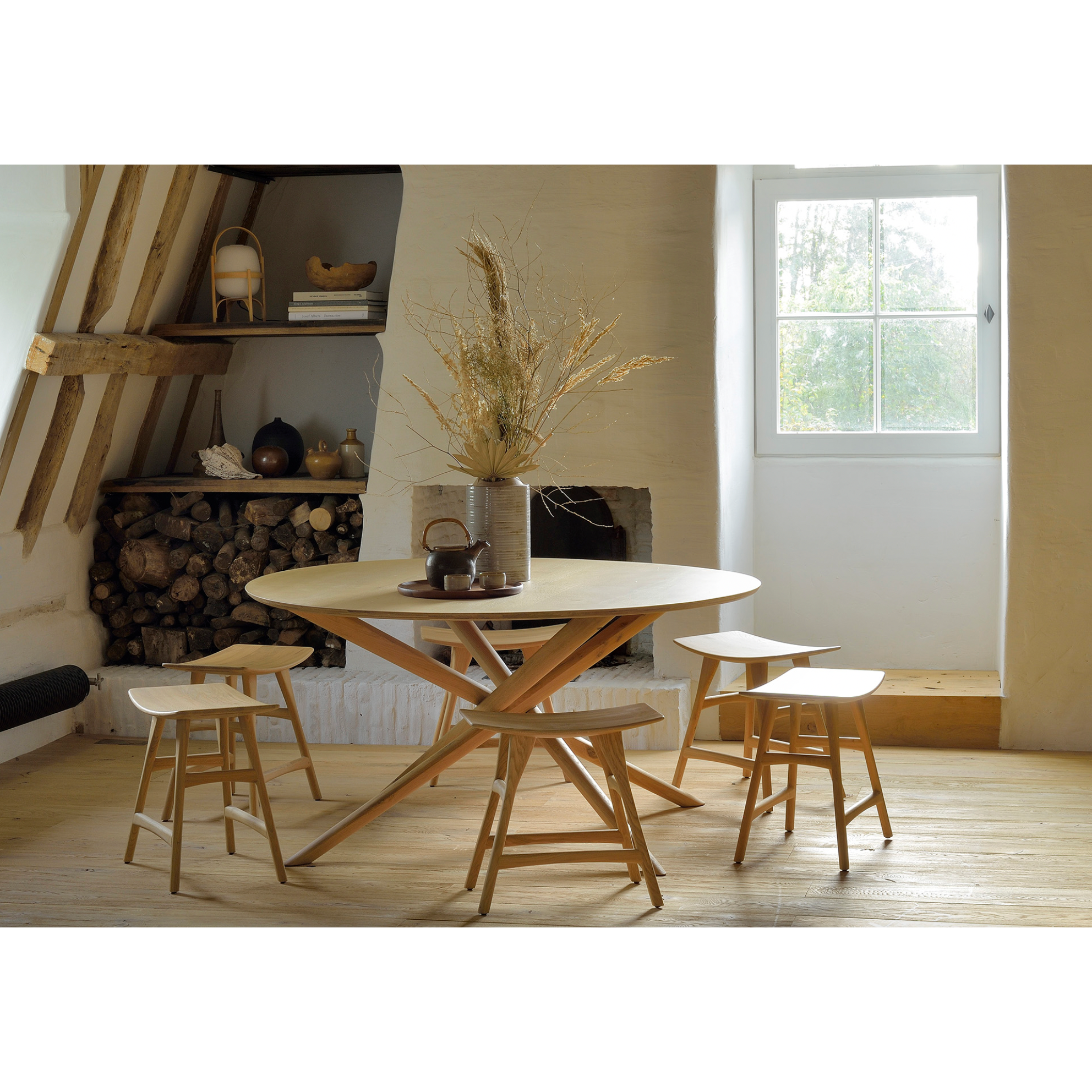 We love the sculptural character of this Oak Mikado Dining Table - Round. The legs interlock like a well-thought-out puzzle, making it easier to interact with your guests and allows you to converse with your family and friends for years to come!  Designed by Alain van Havre  Material: Oak, 100% Solid Wood Finish: Oiled