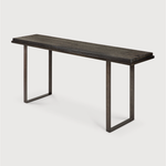 Featuring Stability Console Table - Umber by Ethnicraft at Amethyst Home. The deep surface of the Stability console is shaped by hand by skilled artisans. Natural mineral powders and color pigments blend to form the console's unique finish. We love how this piece's simple lines showcase the clean beauty of well-crafted metal work. We imagine this unique piec.  Amethyst Home provides interior design, new home construction design consulting, vintage area rugs, and lighting in the Houston metro area.