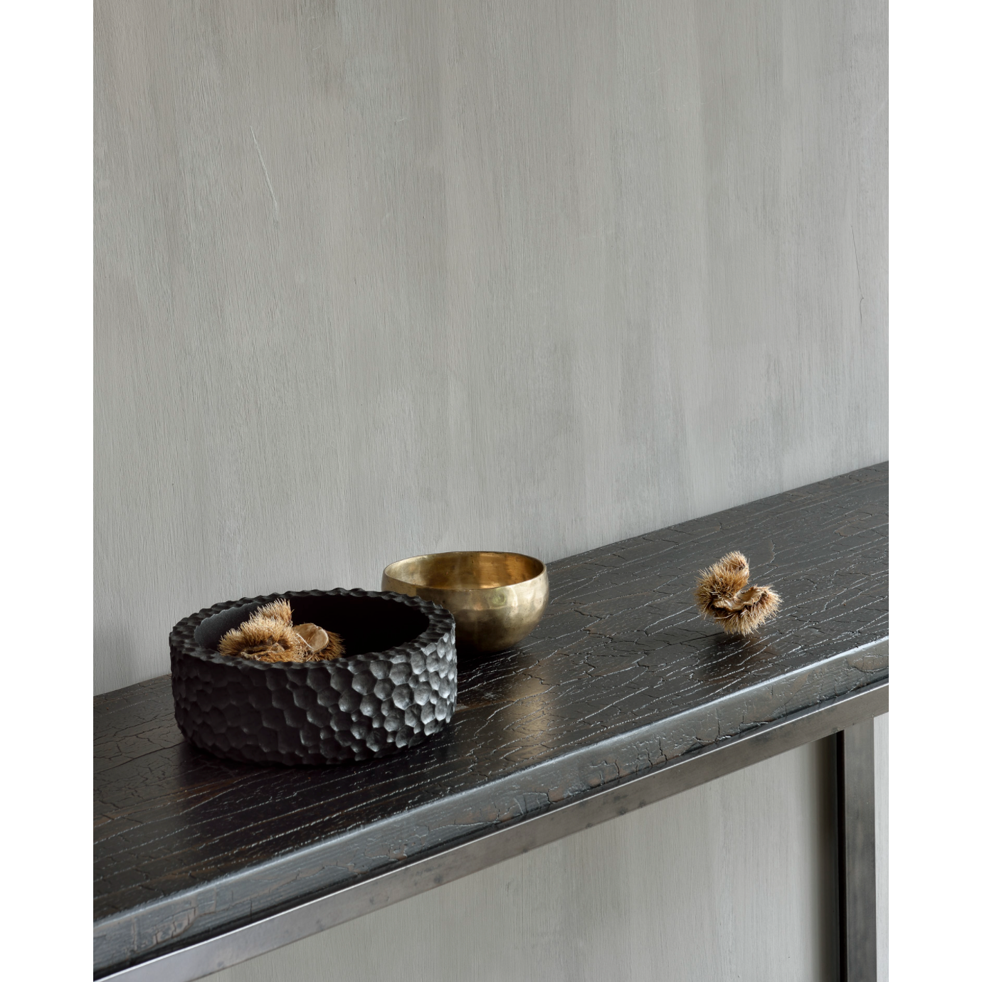 Featuring Stability Console Table - Umber by Ethnicraft at Amethyst Home. The deep surface of the Stability console is shaped by hand by skilled artisans. Natural mineral powders and color pigments blend to form the console's unique finish. We love how this piece's simple lines showcase the clean beauty of well-crafted metal work. We imagine this unique .  Amethyst Home provides interior design, new home construction design consulting, vintage area rugs, and lighting in the Los Angeles metro area.