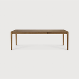 This Oak Bok Extendable Dining Table is perfect for families who want extra space when their kids, extended family, or guests come to celebrate! Its airy shape yet rock solid construction make this piece a timeless and remarkable design to enjoy for years to come.  Material: Oak, 100% Solid Wood Finish: Oiled