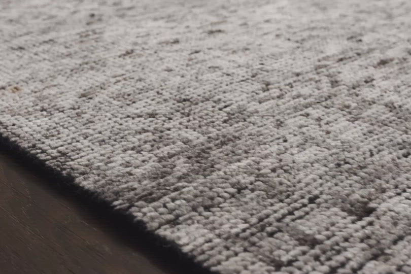 Hand-knotted in India of 100% wool, the Amara Ivory/Taupe Area Rug creates a casual yet refined vibe with high-end appeal. With shades of ivory, taupe, and black, this is a gorgeous rug to showcase in your living room, entryway, bedroom, or other high traffic area.   Hand Knotted 100% Wool AMM-04 Ivory/Taupe
