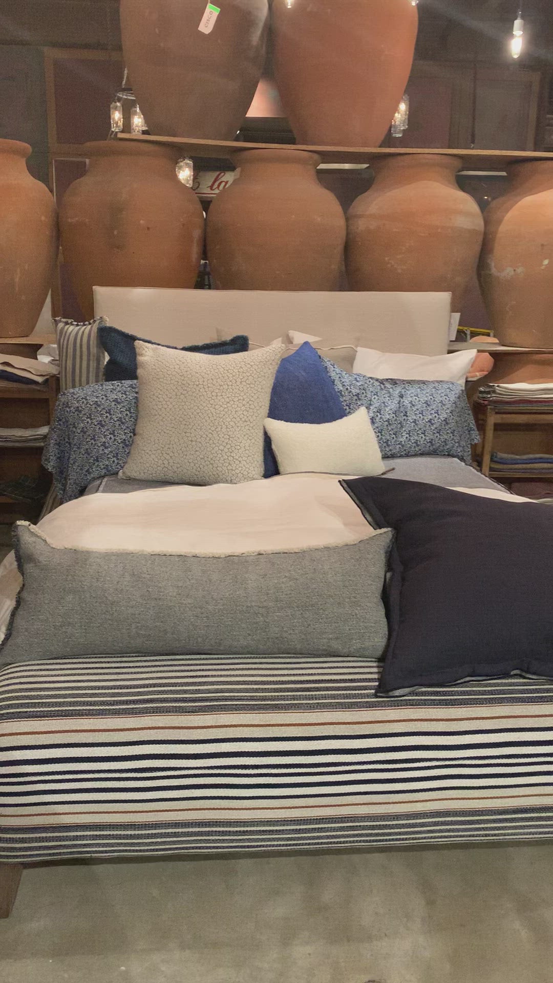 Load video: Cisco Brothers April Bed is designed and constructed in Los Angeles. The pinched edges and clean lines bring a modern, minimalist feel to any bedroom. Photographed in White Denim and Bengal Pin Striped Indigo. Amethyst Home provides interior design, new home construction design consulting, vintage area rugs, and lighting in the Alpharetta metro area.