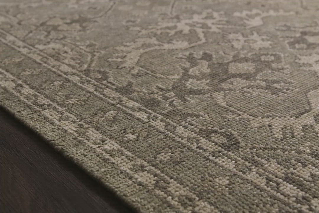 Load video: Bring a touch of antiqued beauty into your home with the Heirloom Fog / Fog Area rug from Loloi. This wool rug tastefully honors the art of hand knotted rugs. The rug evokes a sense of unique sophistication with its traditional Serapi rug color palettes and vintage design.  This rug would be perfect for a living room, dining room, bedroom, hallway or kitchen runner with it&#39;s patterns and calming tones for your home.  Hand Knotted 83% Wool | 17% Cotton HQ-03 Fog / Fog