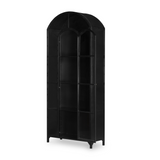 Display barware, books, or other treasures in an arch-topped cabinet. Solid iron sheeting is finished in soft, matte black with contrasting brass hardware.  Overall Dimensions: 39.50"w x 15.75"d x 92.50"h Colors: Black, Clear Glass Materials: Iron, Glass Weight: 235.89 lb