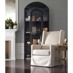 Display barware, books, or other treasures in an arch-topped cabinet. Solid iron sheeting is finished in soft, matte black with contrasting brass hardware. Amethyst Home provides interior design, new home construction design consulting, vintage area rugs, and lighting in the Winter Garden metro area.