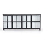 A black iron frame with windowpane detail contrasts a stark white interior for an updated take on the traditional media console. Open-front glass doors and ample shelving maximize storage and display options.  Size: 94.50"w x 16.00"d x 39.50"h Colors: Tempered Glass, Painted White, Black Materials: Glass, Iron