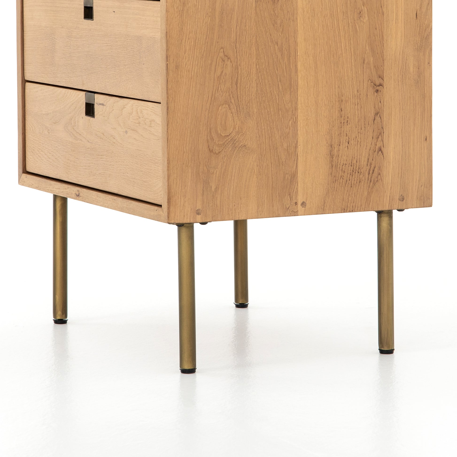 Style meets simplicity in this Danish-inspired design. Solid natural oak forms clean lines, welcoming dual drawers with squared iron hardware in a satin brass finish. Great solo or in pairs, for handy bedside storage.  Overall Dimensions: 24.00"w x 18.00"d x 23.00"h Colors: Satin Brass, Natural Oak Materials: Iron, Oak