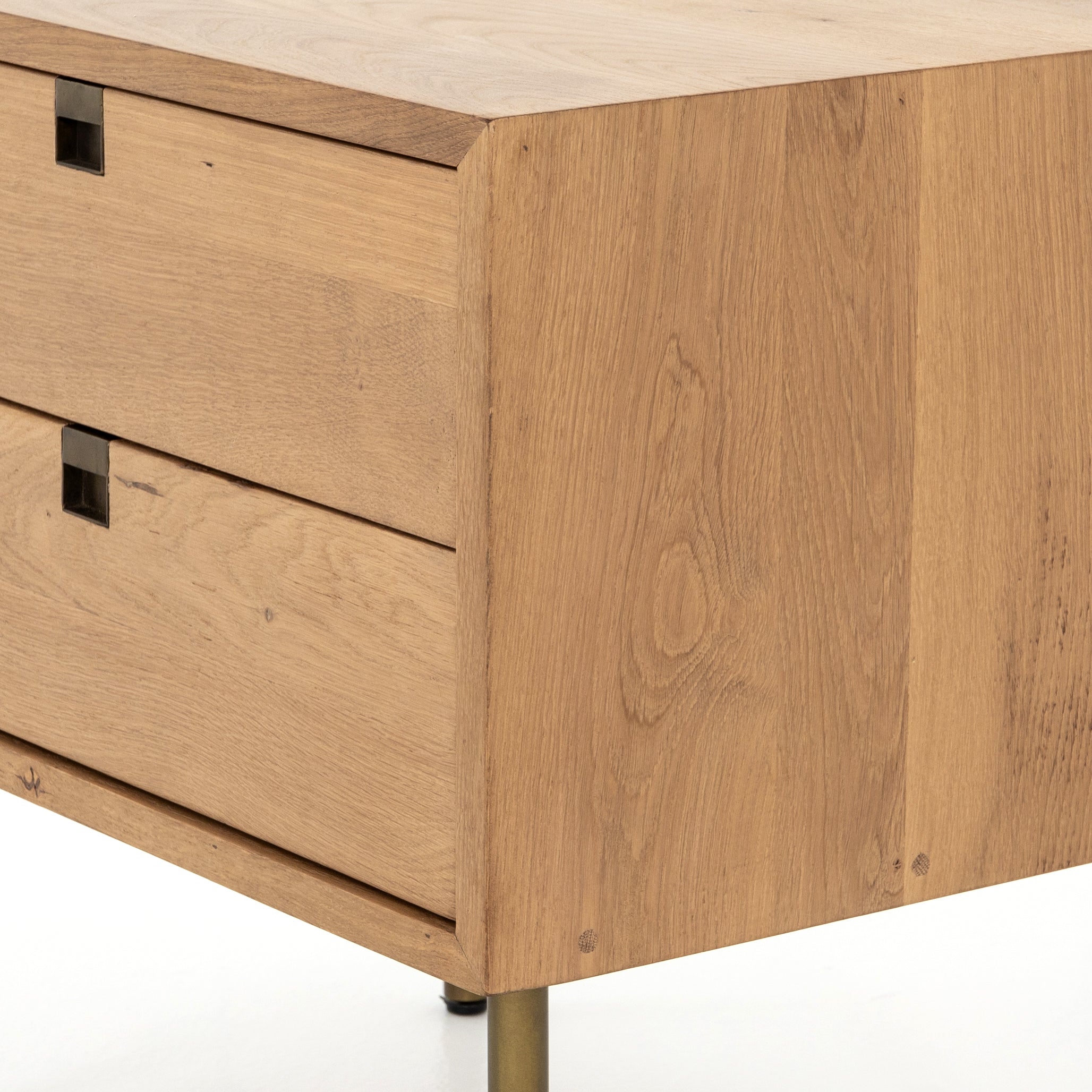 Style meets simplicity in this Danish-inspired design. Solid natural oak forms clean lines, welcoming dual drawers with squared iron hardware in a satin brass finish. Great solo or in pairs, for handy bedside storage.  Overall Dimensions: 24.00"w x 18.00"d x 23.00"h Colors: Satin Brass, Natural Oak Materials: Iron, Oak