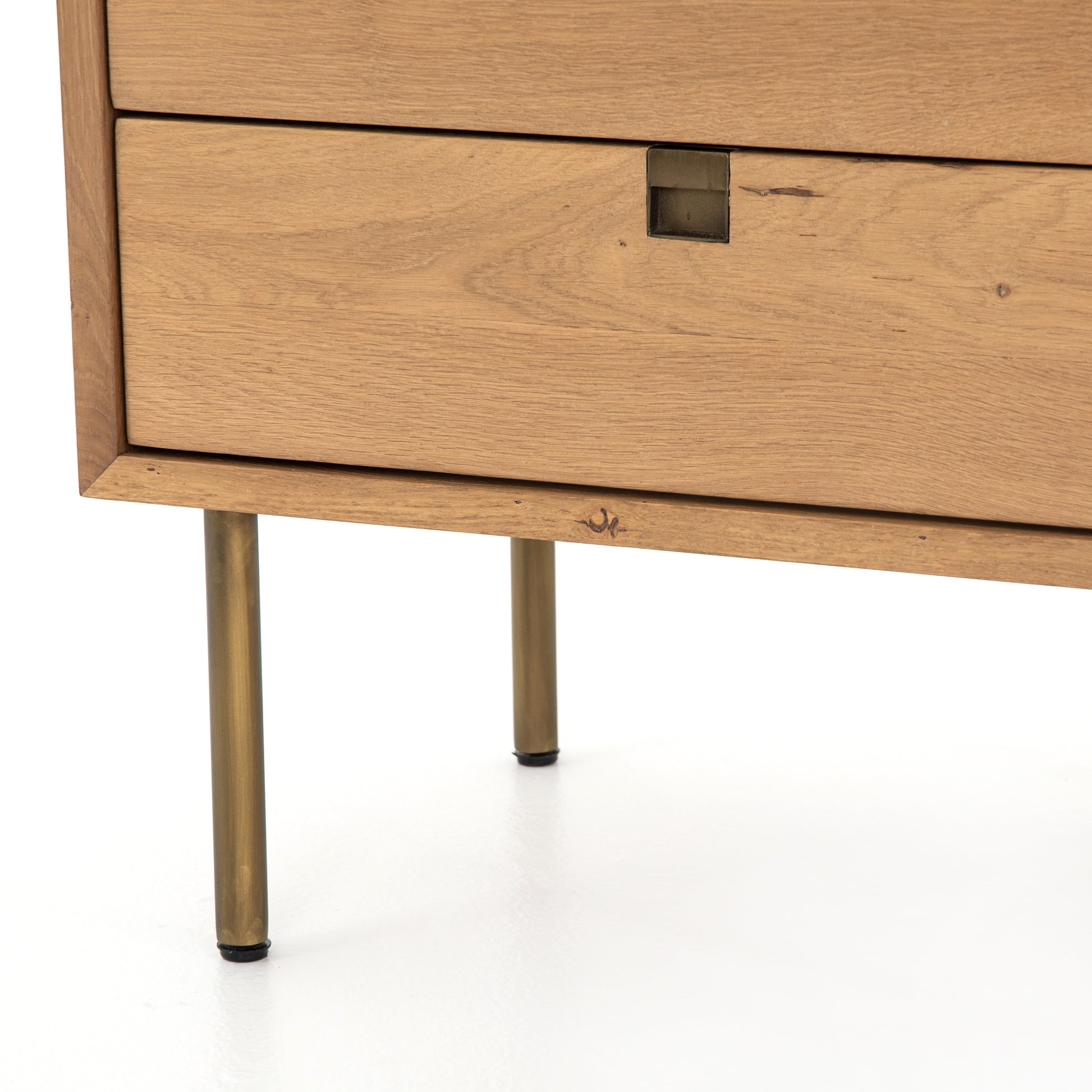 Style meets simplicity in this Danish-inspired design. Solid natural oak forms clean lines, welcoming dual drawers with squared iron hardware in a satin brass finish. Great solo or in pairs, for handy bedside storage.  Overall Dimensions: 24.00"w x 18.00"d x 23.00"h Colors: Satin Brass, Natural Oak Materials: Iron, Oak