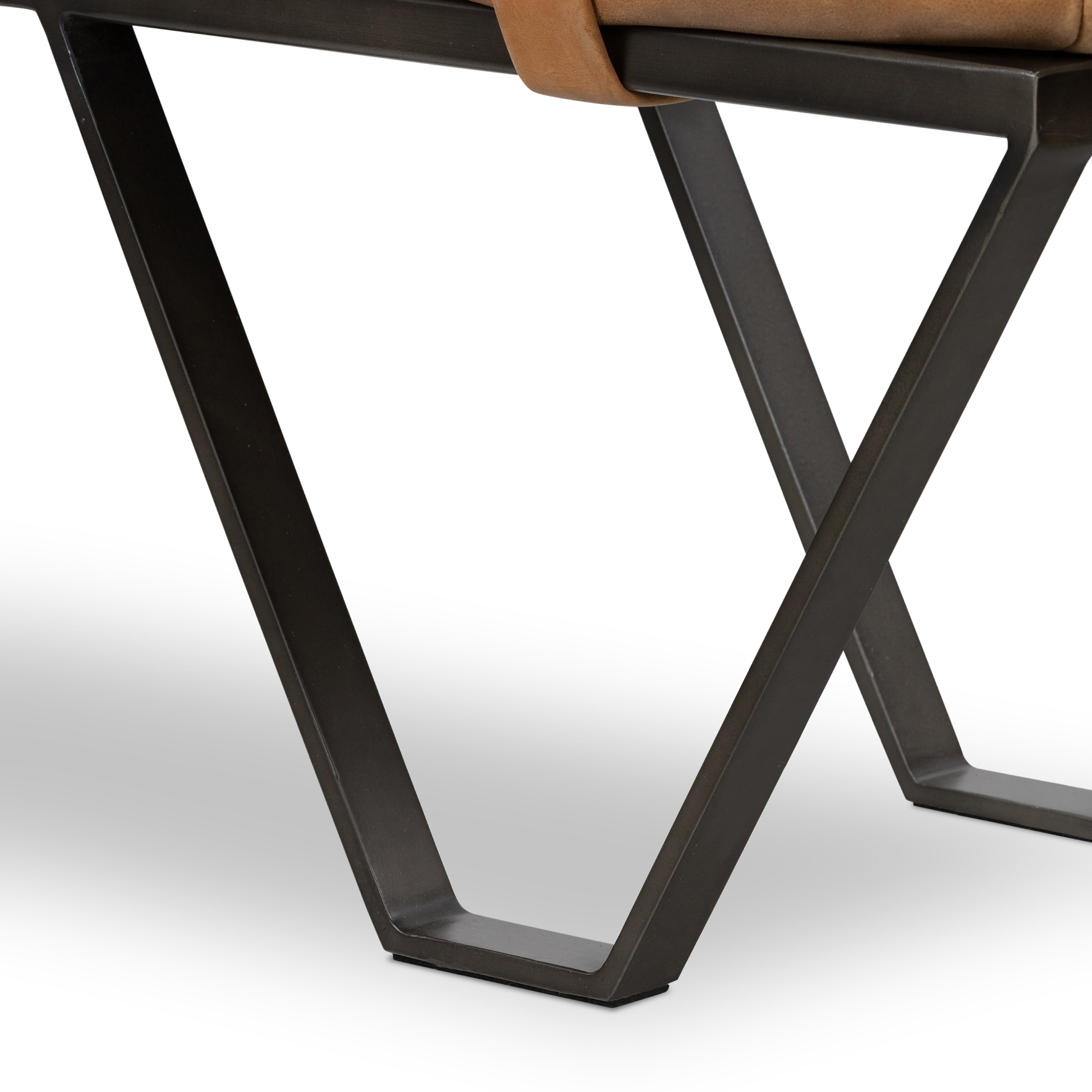 The Darrow Bench -  Palermo Cognac is a time-honored bench, reinvented. With fresh, clever shaping, angular gunmetal-finished iron supports spare-yet-comfortable top-grain leather cushioning in a rich cognac.  Overall Dimensions: 63.50"w x 17.50"d x 17.75"h