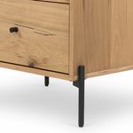 This Eaton Nightstand - Light Oak has a gorgeous, thick oak veneer with thin, iron legs. With one large drawer and two smaller drawers, this is the perfect nightstand to complete your bedroom.   Overall Dimensions: 23.50"w x 18.50"d x 26.00"h Colors: Dark Gunmetal, Light Oak Resin Materials: Iron, Thick Oak Veneer