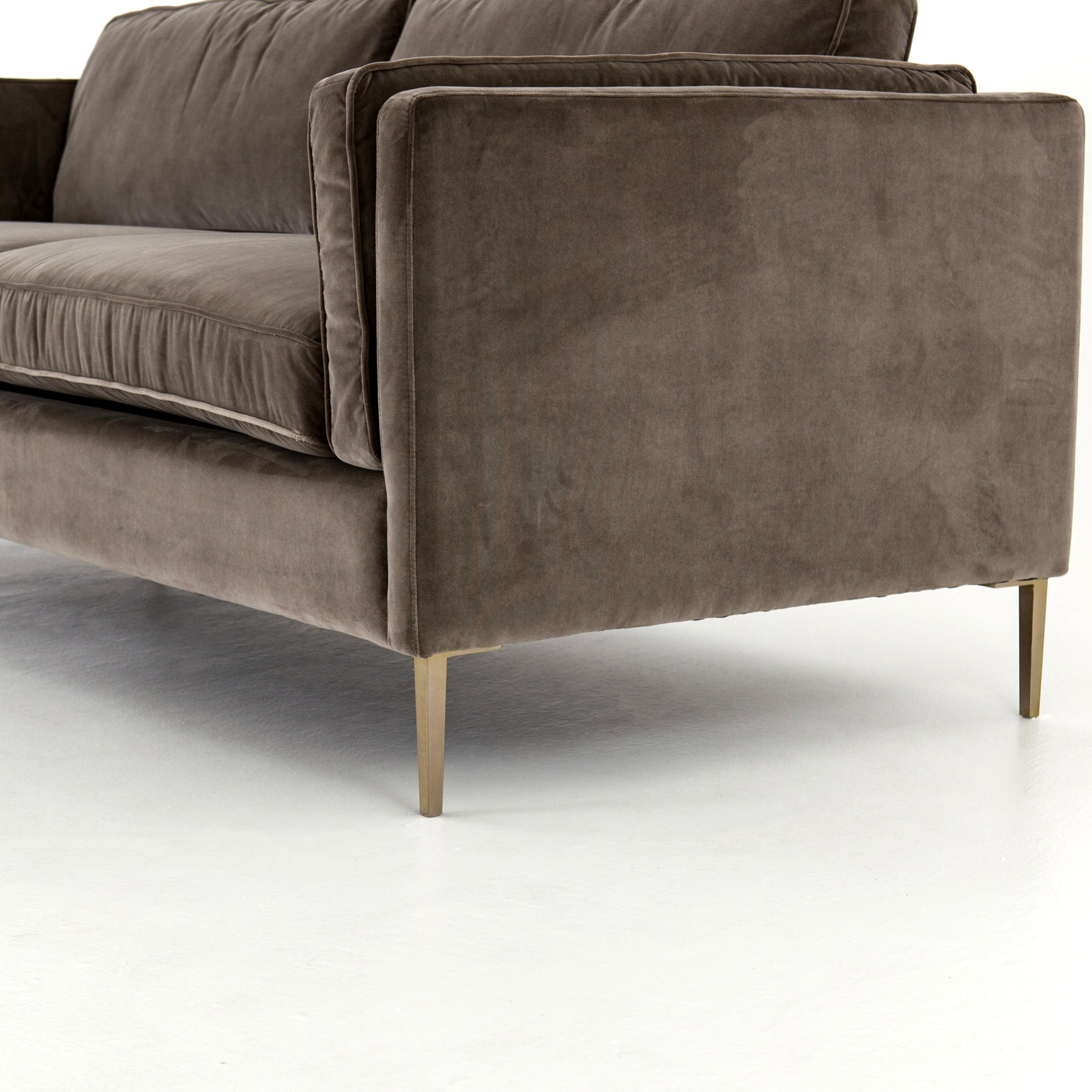 We love the plush brich-grey upholstery of this Emery Sofa - Sapphire Birch. The slim legs are finished in a gorgeous antique brass, for a sophisticated look for any living room or lounge area.   Overall Dimensions: 84.00"w x 36.00"d x 33.00"h