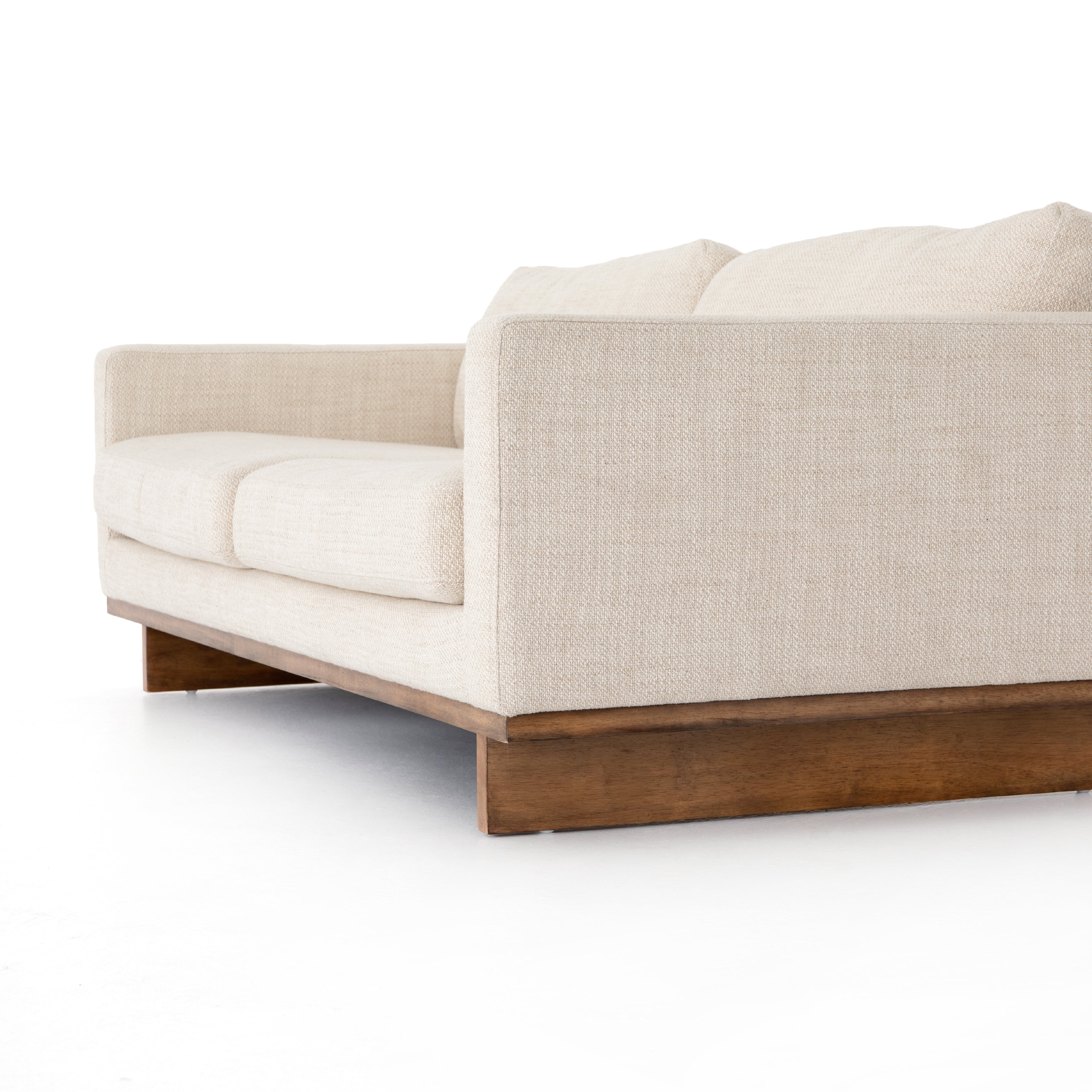 Classic goes contemporary with this Everly Sofa - Irving Taupe. A cocoa-finished parawood base supports low, deep seating of performance-grade upholstery in an invitingly neutral taupe, with track arms for a clean touch for any living room or lounge area.   Overall Dimensions: 84.00"w x 43.00"d x 32.00"h