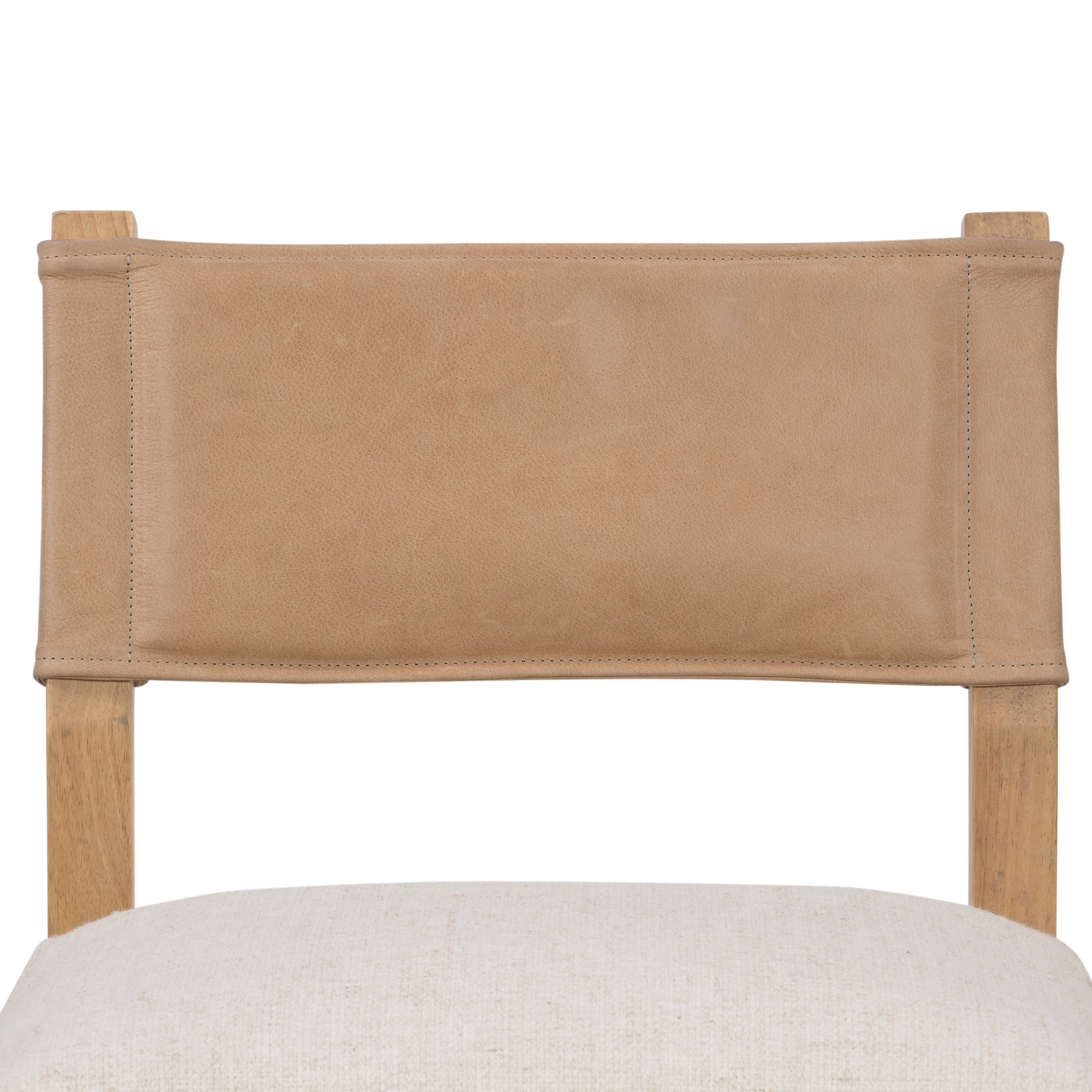 We love the mixed materials found on this Ferris Dining Chair - Winchester Beige. Solid parawood forms a slight, simple frame for squared seating upholstered in high-performance fabric. Tan top-grain leather backing takes this modern-minded dining chair to the next level.  Overall Dimensions: 20.00"w x 21.75"d x 32.00"h