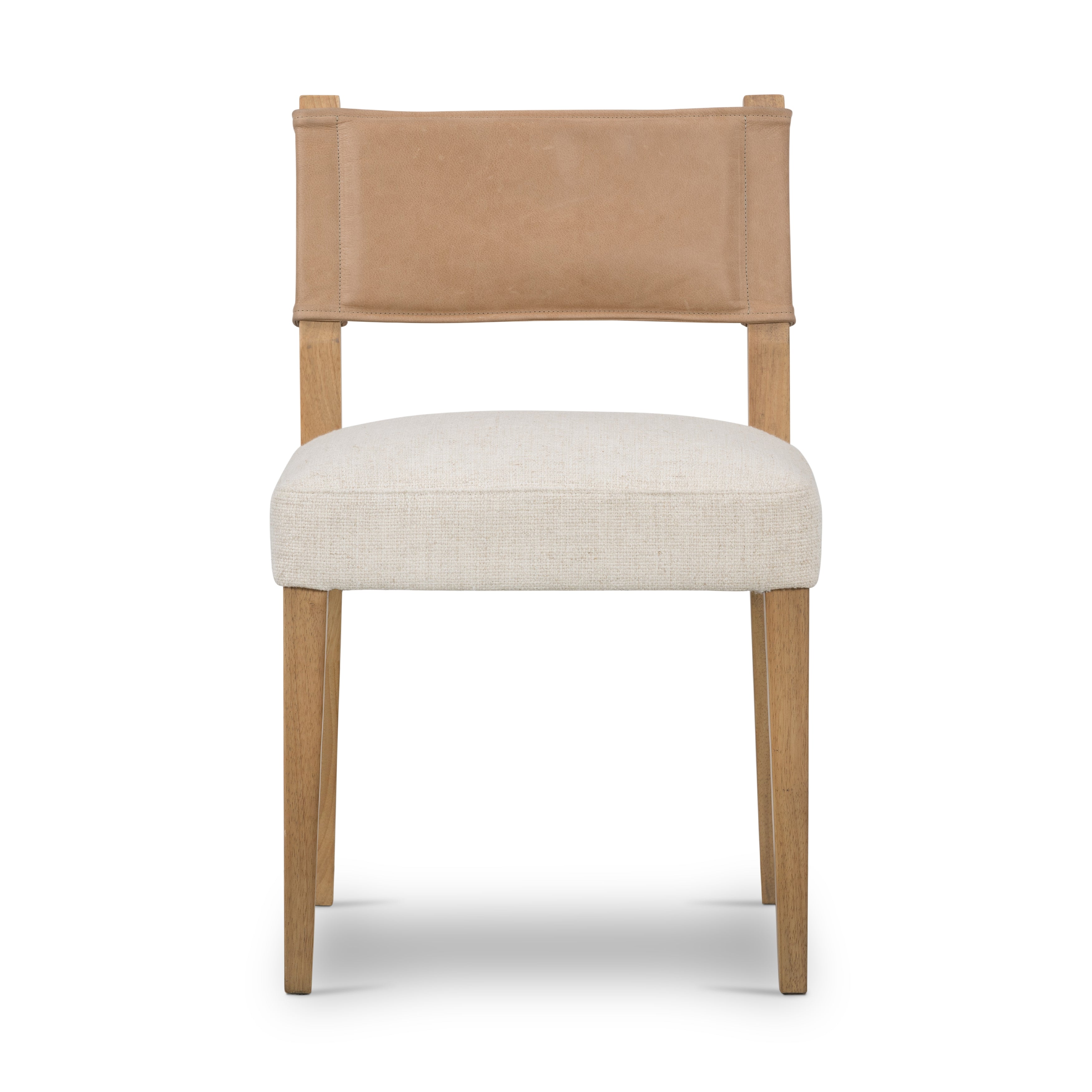 We love the mixed materials found on this Ferris Dining Chair - Winchester Beige. Solid parawood forms a slight, simple frame for squared seating upholstered in high-performance fabric. Tan top-grain leather backing takes this modern-minded dining chair to the next level.  Overall Dimensions: 20.00"w x 21.75"d x 32.00"h