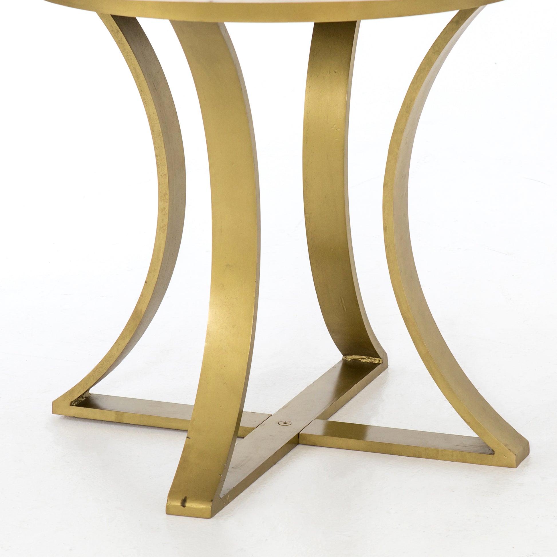 Sophisticated materials take a cue from modern geometry. Cast brass iron forms uniquely-curved angles to balance a contrasting polished white marble top. A refined spin on trend-forward design.  Dimensions: 48"w x 48"d x 30"h, or 60"w x 60"d x 30"h    Colors: Cast Brass, Polished White Marble Materials: Iron, Marble