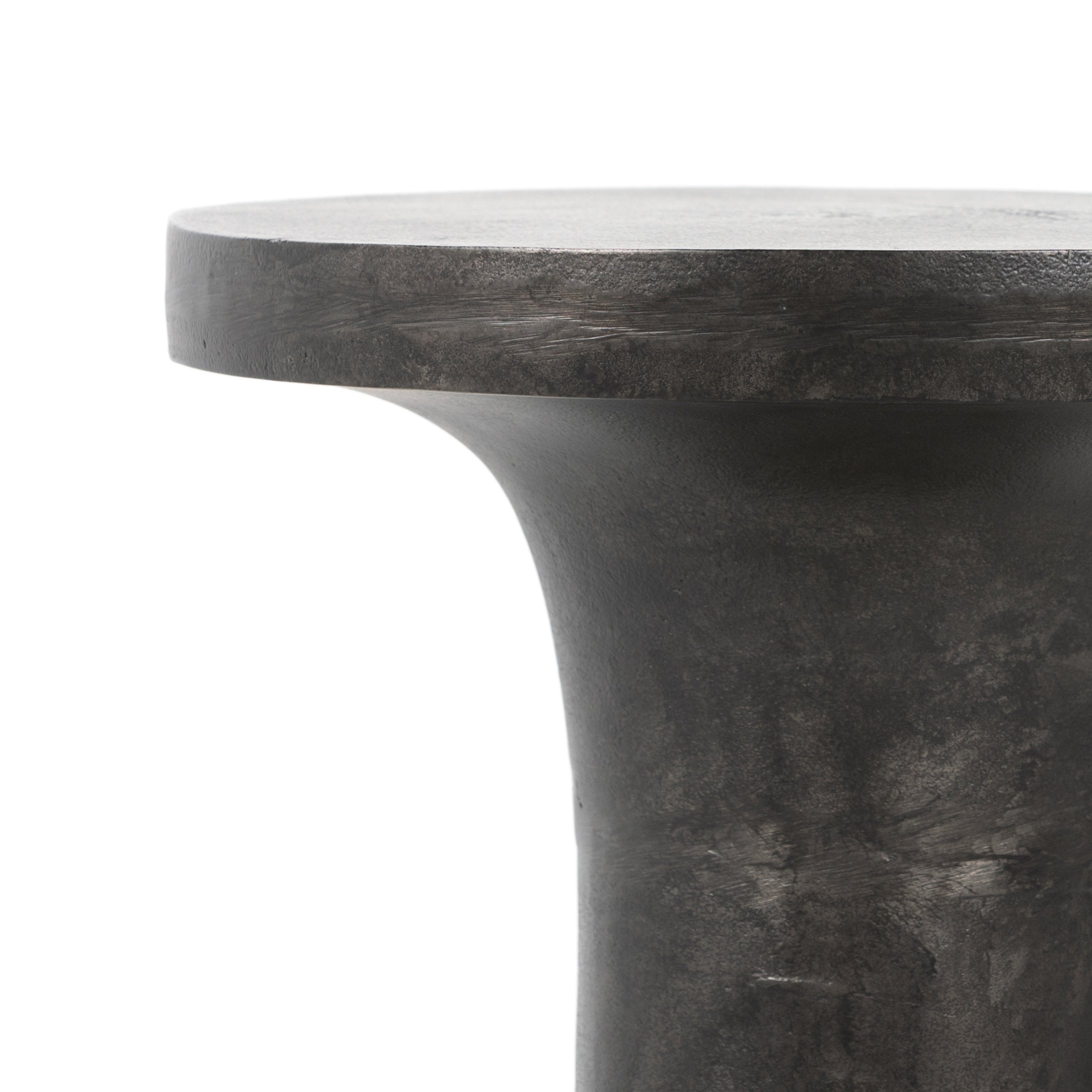 Made from raw black cast aluminum, a dramatically tapered Gino End Table - Raw Black flaunts beautiful high/ low hues and subtle Brutalist vibes. Perfect for setting your book or favorite drink next to.   Overall Dimensions: 13.00"w x 13.00"d x 20.00"h