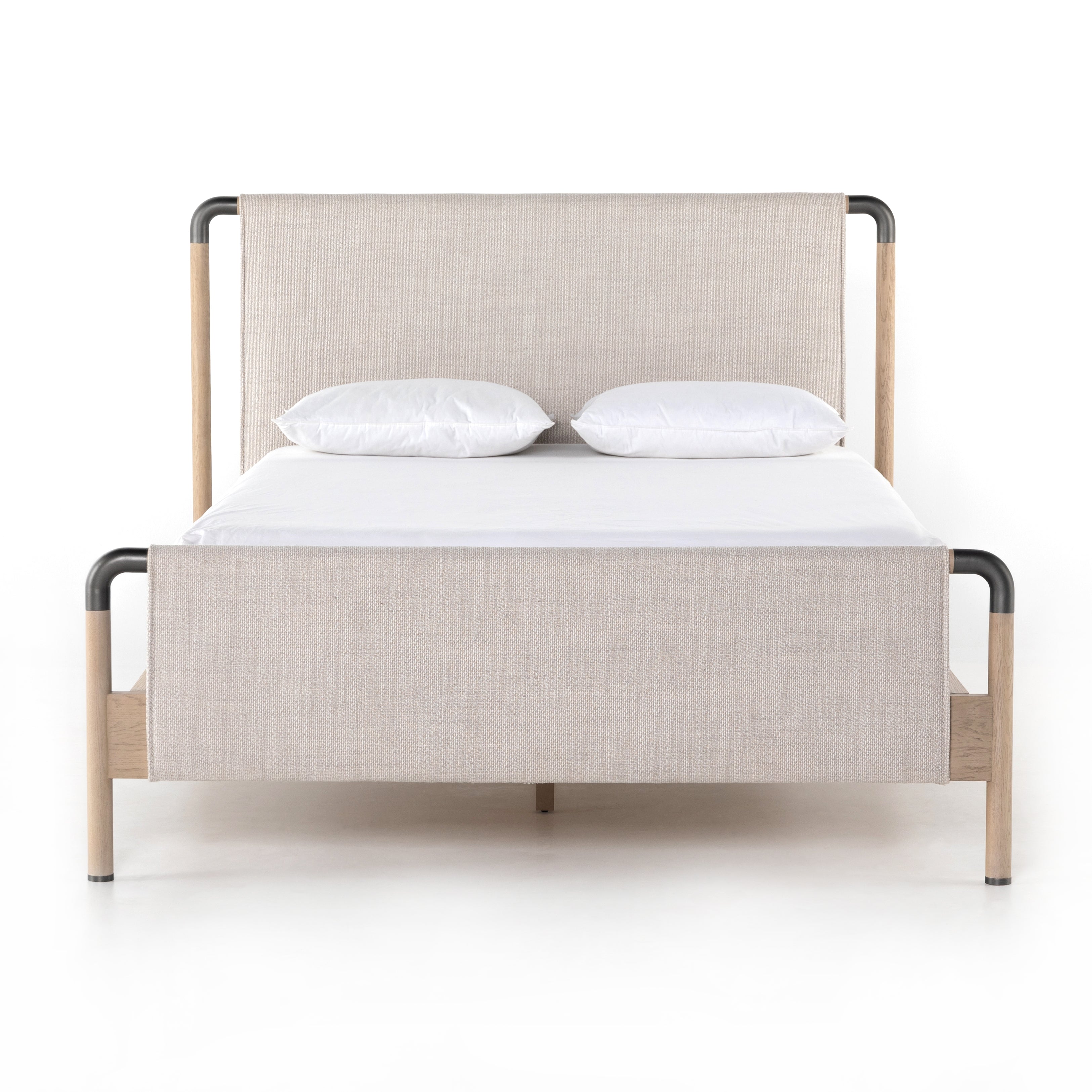 We love the mixed materials of this Harriet Bed. Framed by solid oak with rounded iron corners, an upholstered, sling-style headboard brings a light, modern vibe to any bedroom. Queen Overall Dimensions: 70.50"w x 88.50"d x 51.00"h  King Overall Dimensions: 86.50"w x 88.50"d x 51.00"h
