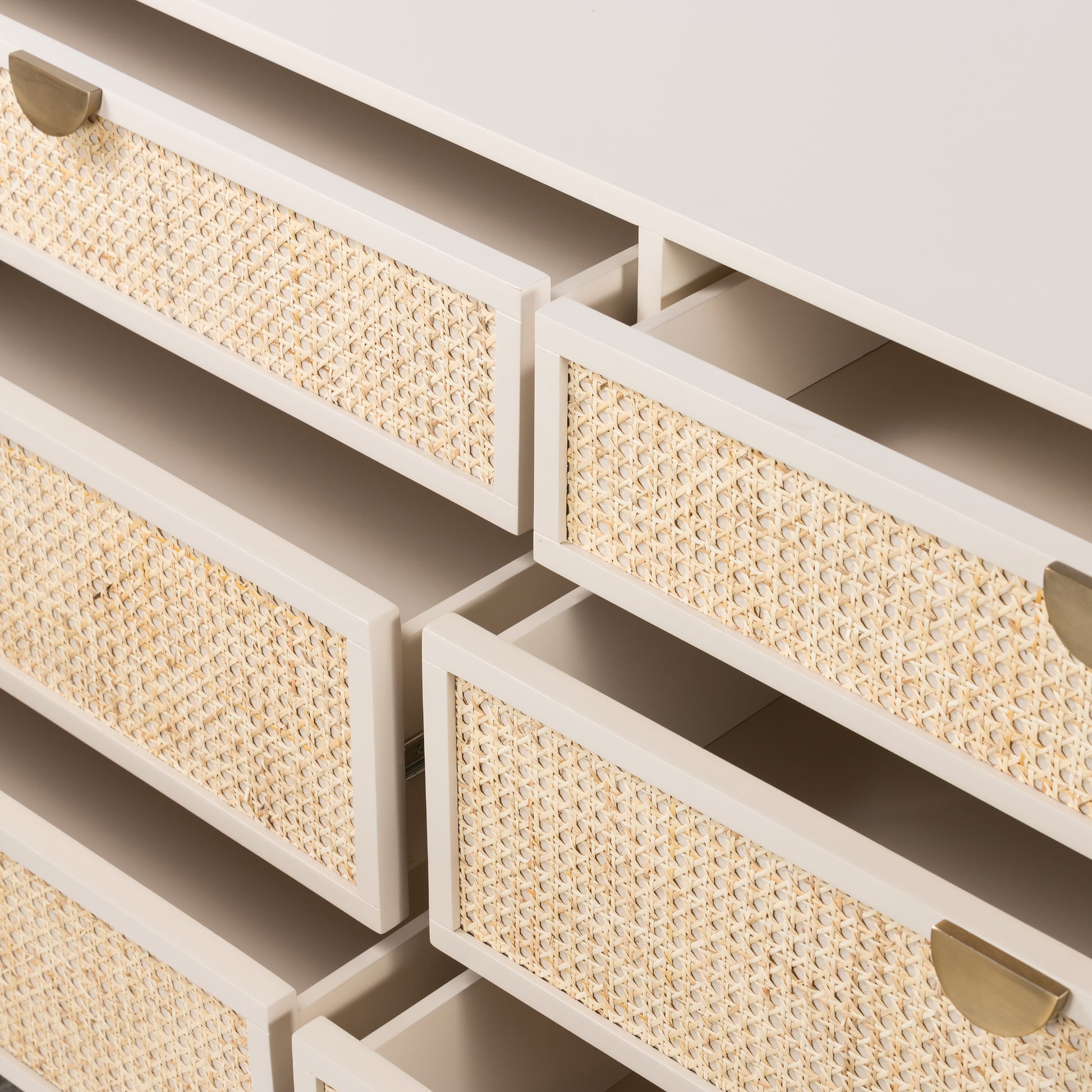 Bring a light look to bedroom styling with this Luella 6 Drawer Dresser - Matte Alabaster. A lacquered six-drawer dresser features woven cane panels and half-moon hardware finished in an aged brass for a beautiful + functional dresser in any bedroom!  Overall Dimensions: 64.00"w x 19.00"d x 33.50"h