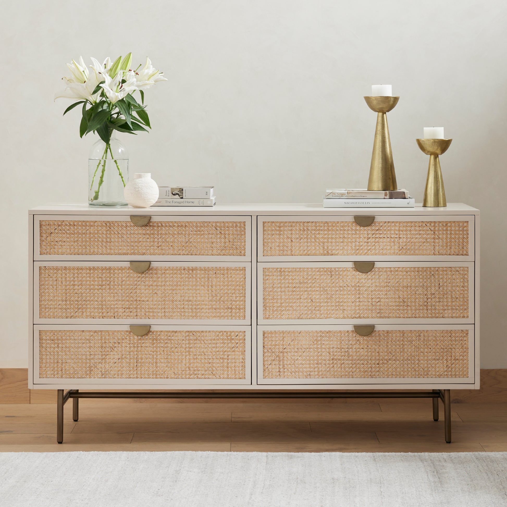 Bring a light look to bedroom styling with this Luella 6 Drawer Dresser - Matte Alabaster. A lacquered six-drawer dresser features woven cane panels and half-moon hardware finished in an aged brass for a beautiful + functional dresser in any bedroom!  Overall Dimensions: 64.00"w x 19.00"d x 33.50"h