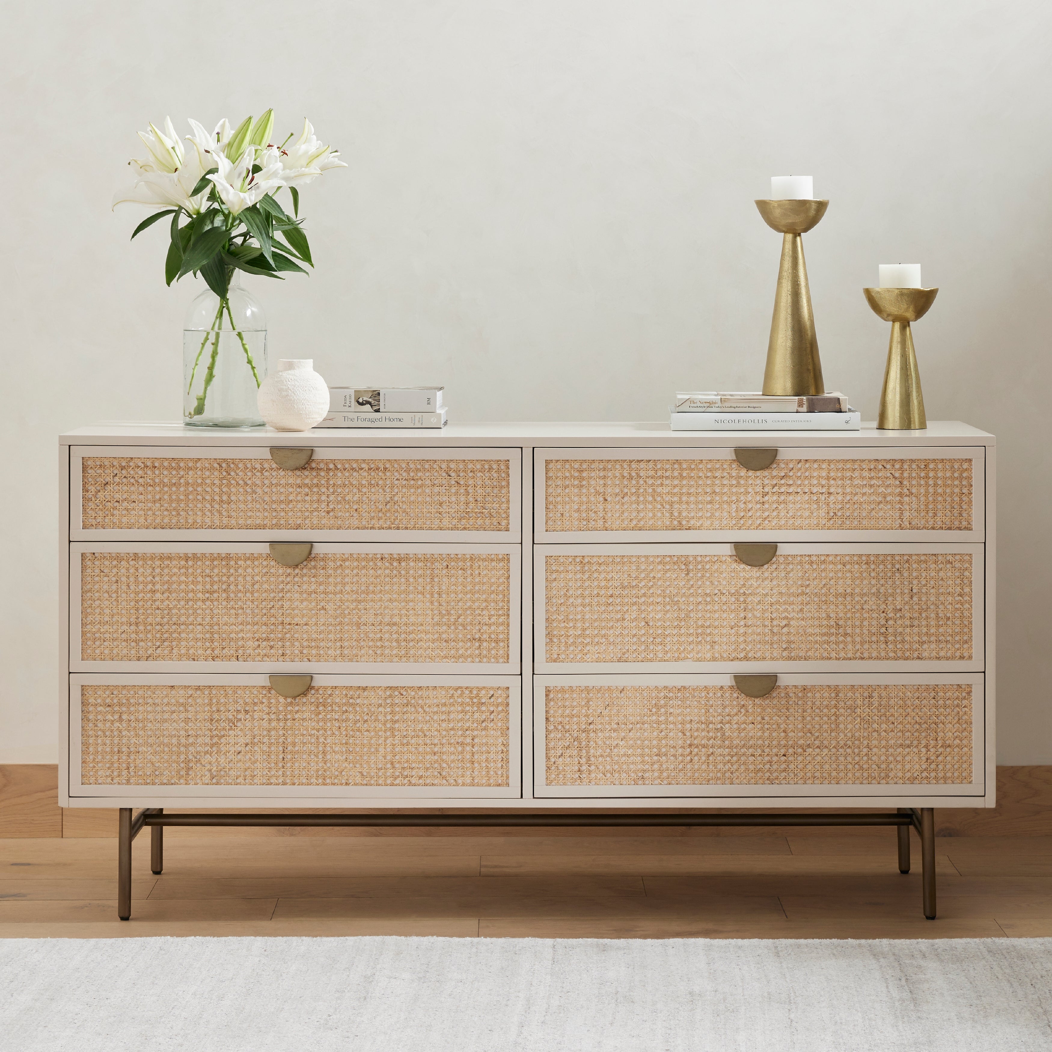 Bring a light look to bedroom styling with this Luella 6 Drawer Dresser - Matte Alabaster. A lacquered six-drawer dresser features woven cane panels and half-moon hardware finished in an aged brass for a beautiful + functional dresser in any bedroom!  Overall Dimensions: 64.00"w x 19.00"d x 33.50"h