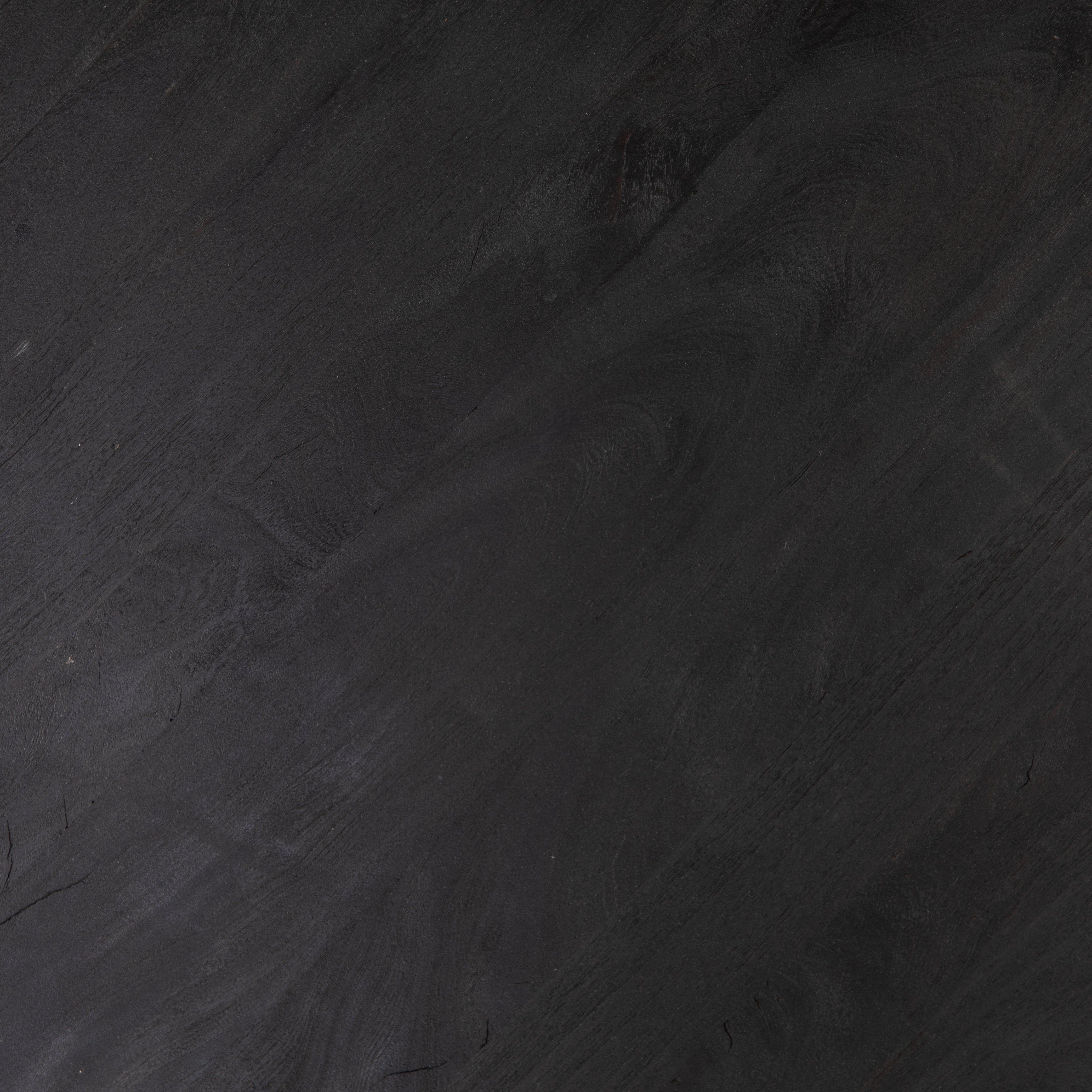 We love the shapely, substantial legs that support a slim, rounded tabletop of light black-finished reclaimed woods in this Maricopa Coffee Table - Dark Totem. A global, organic look with a handcrafted vibe.