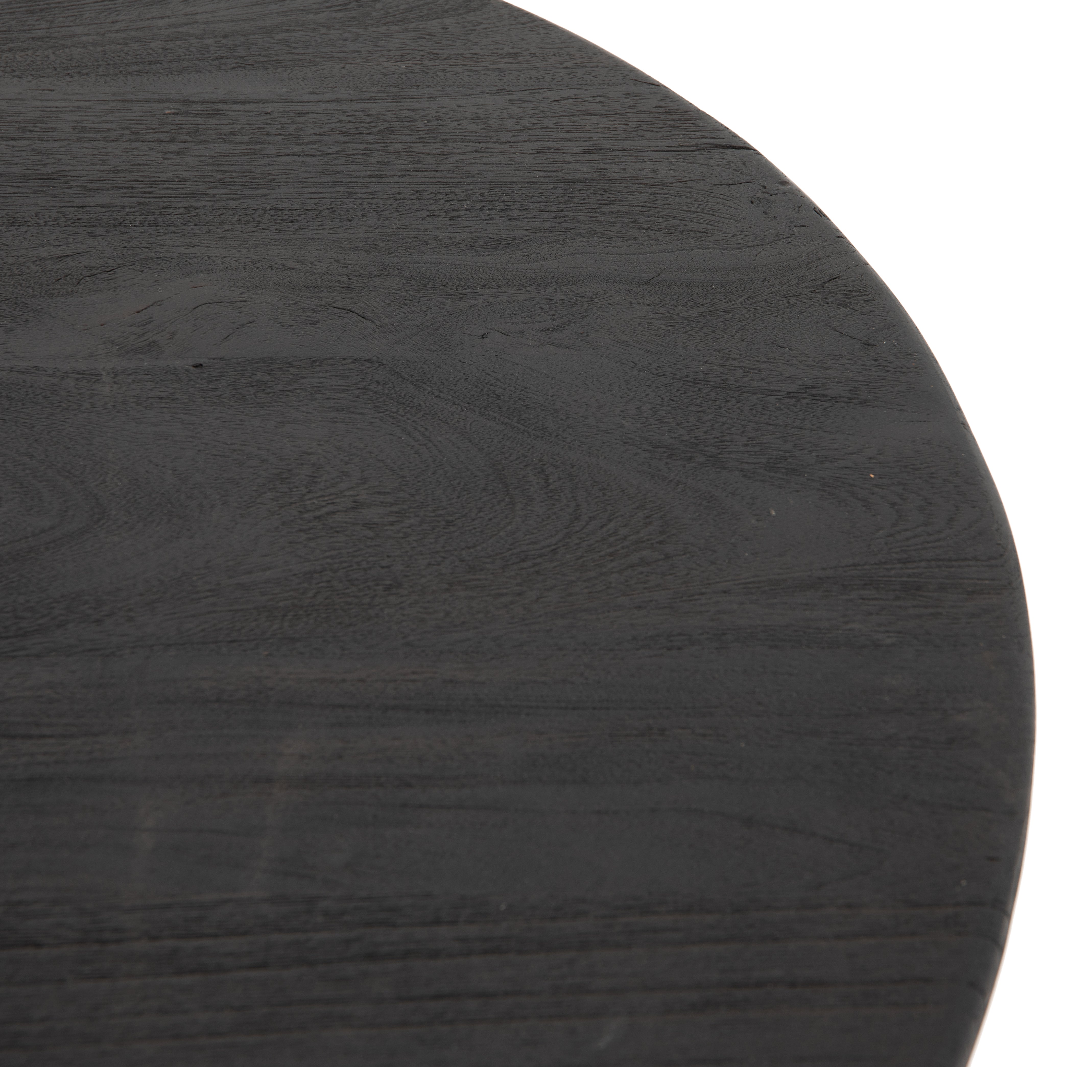 We love the shapely, substantial legs that support a slim, rounded tabletop of light black-finished reclaimed woods in this Maricopa Coffee Table - Dark Totem. A global, organic look with a handcrafted vibe.