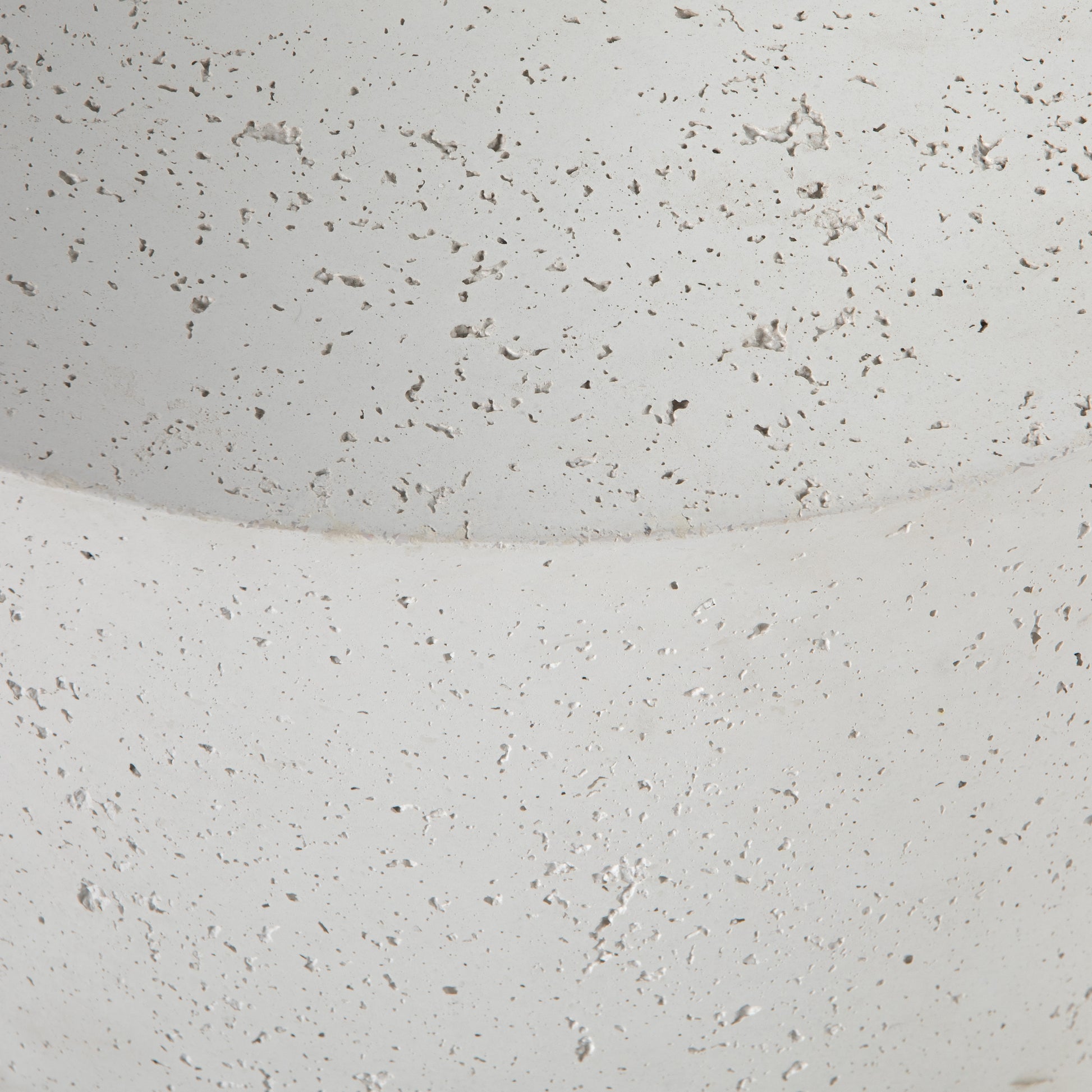 Made from white-finished concrete with deep, textured pitting, this Meza Nesting Coffee Table - Textured White is sturdy and beautiful. Inspired by mid-century coral décor, this nesting coffee table features two tiers for a layered look with modernity.  Overall Dimensions: 43.75"w x 28.25"d x 19.00"h