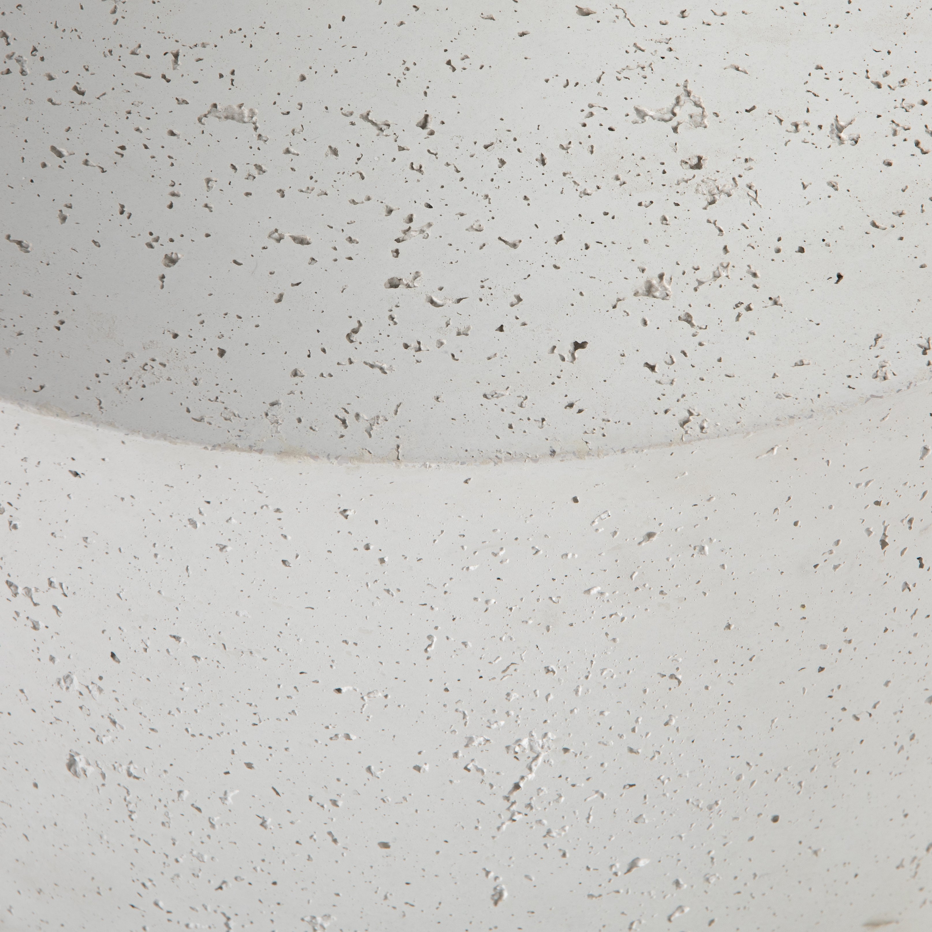 Made from white-finished concrete with deep, textured pitting, this Meza Nesting Coffee Table - Textured White is sturdy and beautiful. Inspired by mid-century coral décor, this nesting coffee table features two tiers for a layered look with modernity.  Overall Dimensions: 43.75"w x 28.25"d x 19.00"h
