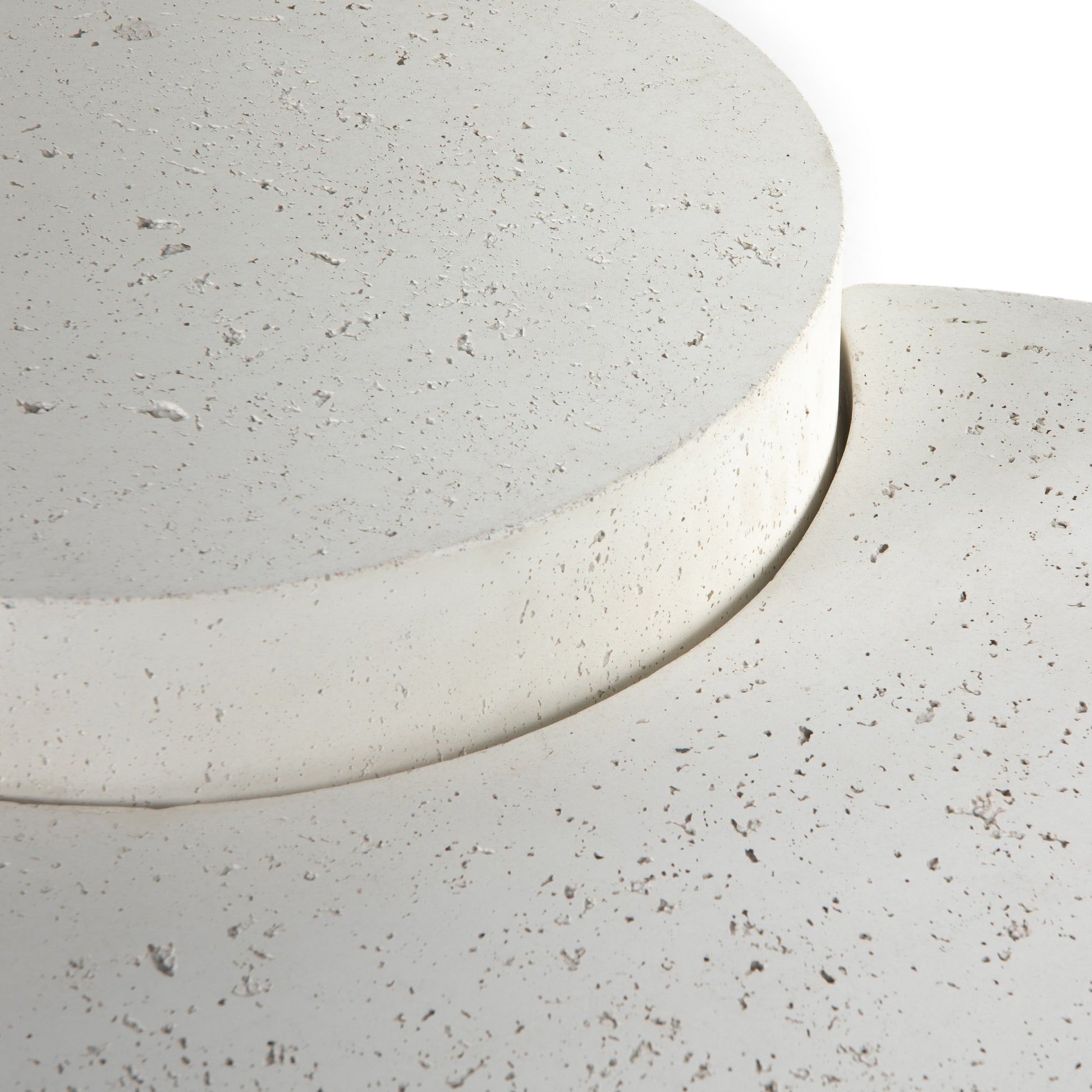 Made from white-finished concrete with deep, textured pitting, this Meza Nesting Coffee Table - Textured White is sturdy and beautiful. Inspired by mid-century coral décor, this nesting coffee table features two tiers for a layered look with modernity.  Overall Dimensions: 43.75"w x 28.25"d x 19.00"h