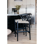 Featuring Muestra Counter + Bar Stool - Black Teak by Four Hands at Amethyst Home. Modern curves redefine the classic wishbone-style of this Muestra Black Teak Counter + Bar Stool. Vintage white all-weather wicker is woven for a dose of fresh texture within weathered grey teak framing. Cover or store indoors during inclement weather and when not in use.
.  Amethyst Home provides interior design, new home construction design consulting, vintage area rugs, and lighting in the Kansas City metro area.