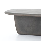 This Naya Outdoor Coffee Table is modern and curve-driven. Dark grey concrete forms a rounded rectangle top with bullnose edging, reminiscent of a shapely surfboard.  Cover or store inside during inclement weather.  Overall Dimensions: 46.00"w x 28.00"d x 16.00"h
