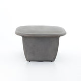 This Naya Outdoor Coffee Table is modern and curve-driven. Dark grey concrete forms a rounded rectangle top with bullnose edging, reminiscent of a shapely surfboard.  Cover or store inside during inclement weather.  Overall Dimensions: 46.00"w x 28.00"d x 16.00"h
