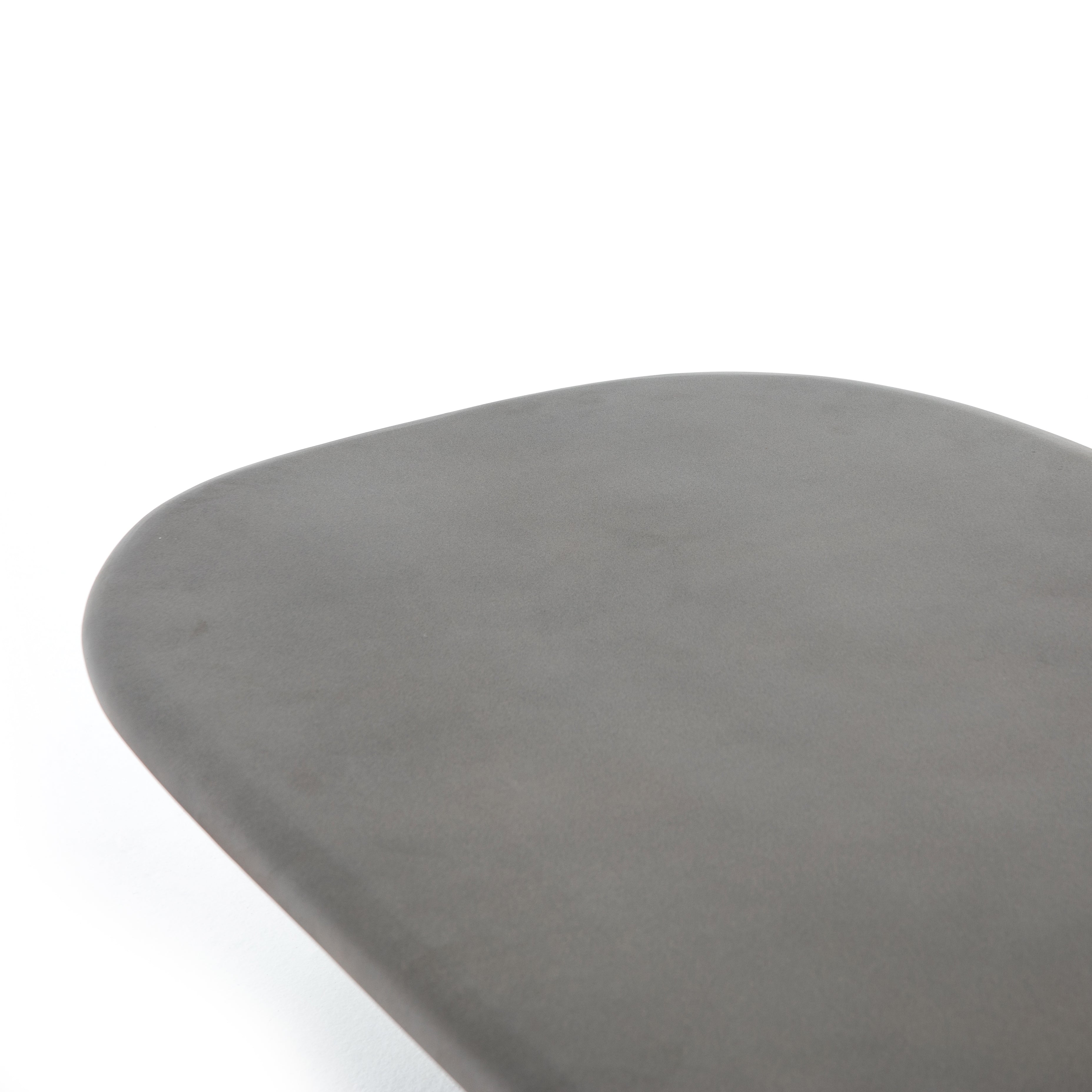 This Naya Outdoor Coffee Table is modern and curve-driven. Dark grey concrete forms a rounded rectangle top with bullnose edging, reminiscent of a shapely surfboard.  Cover or store inside during inclement weather.  Overall Dimensions: 46.00"w x 28.00"d x 16.00"h