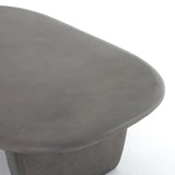 This Naya Outdoor Coffee Table is modern and curve-driven. Dark grey concrete forms a rounded rectangle top with bullnose edging, reminiscent of a shapely surfboard.  Cover or store inside during inclement weather.  Overall Dimensions: 46.00"w x 28.00"d x 16.00"h