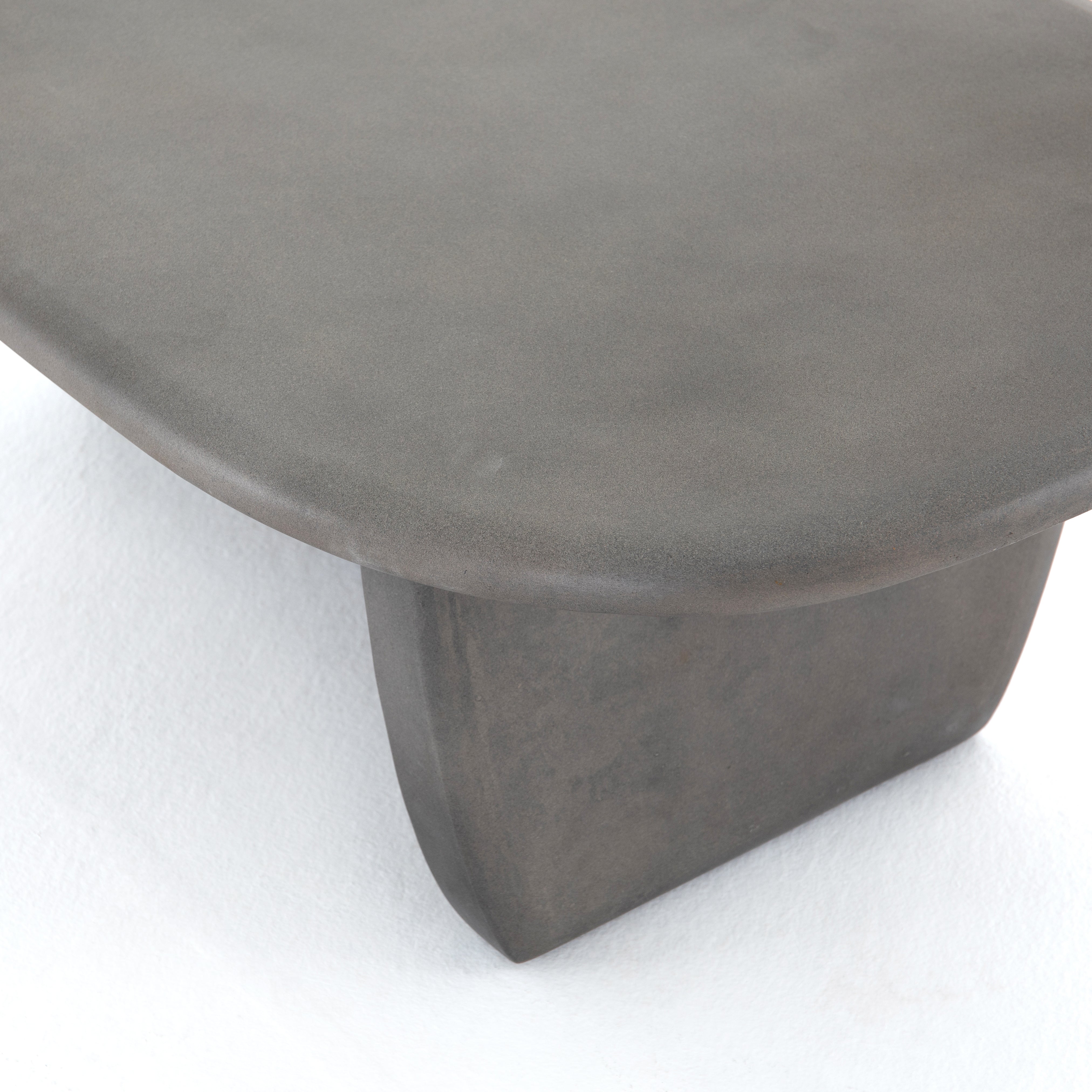 This Naya Outdoor Coffee Table is modern and curve-driven. Dark grey concrete forms a rounded rectangle top with bullnose edging, reminiscent of a shapely surfboard.  Cover or store inside during inclement weather.  Overall Dimensions: 46.00"w x 28.00"d x 16.00"h