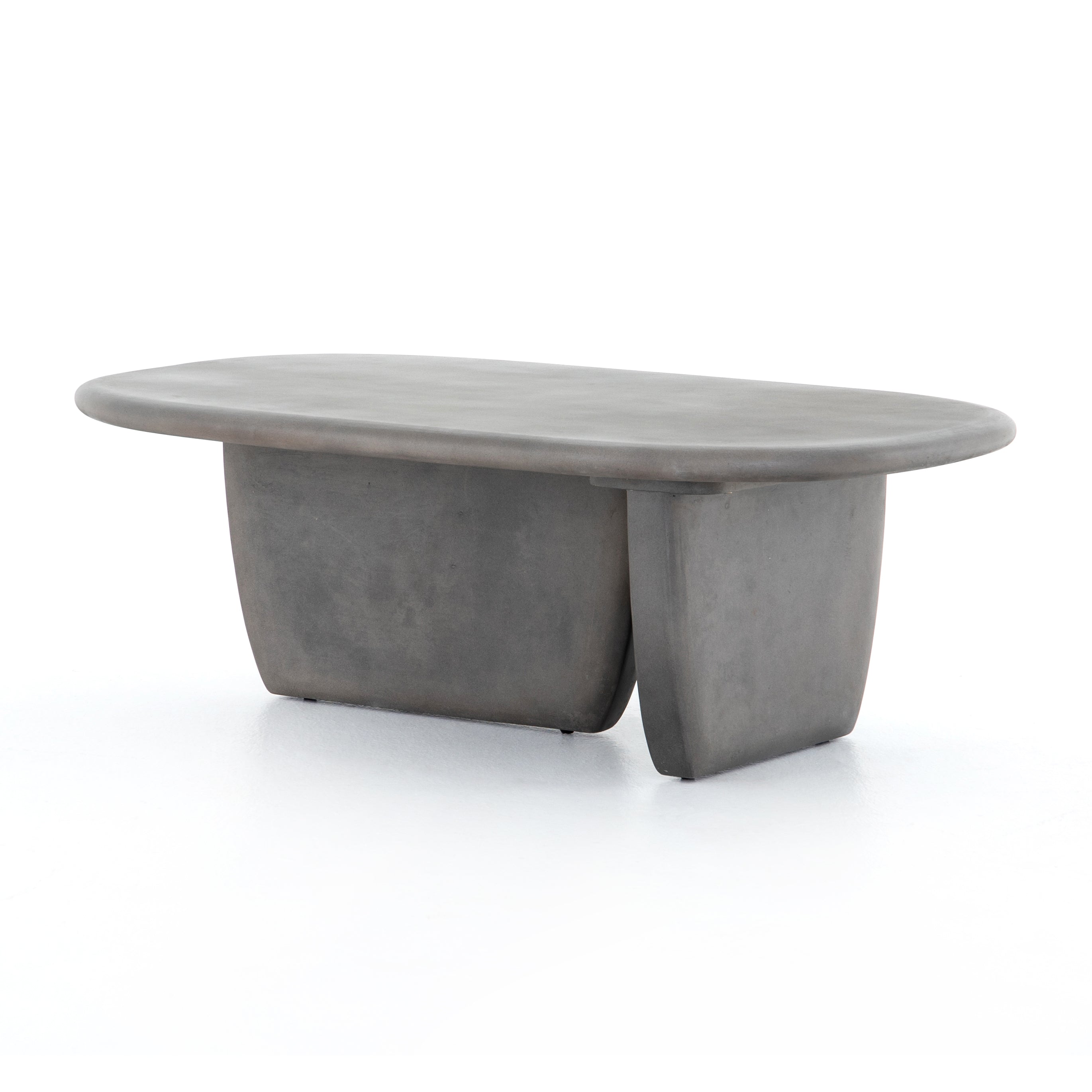 This Naya Outdoor Coffee Table is modern and curve-driven. Dark grey concrete forms a rounded rectangle top with bullnose edging, reminiscent of a shapely surfboard.  Cover or store inside during inclement weather.  Overall Dimensions: 46.00"w x 28.00"d x 16.00"h