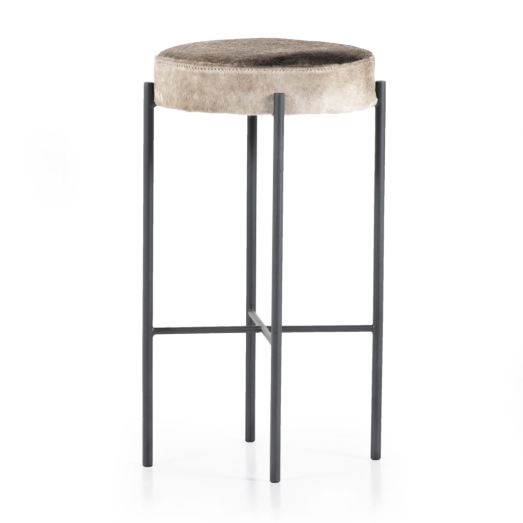 The Nocona Speckled Hide Bar and Counter stool is modern minimalist to a T. Slim and airy, gunmetal-finished iron legs form a cradle-style frame for speckled hide seating, perfectly sized for the counter or bar. Each hide will be unique and will vary. Amethyst Home provides interior design, new home construction design consulting, vintage area rugs, and lighting in the Winter Garden metro area.