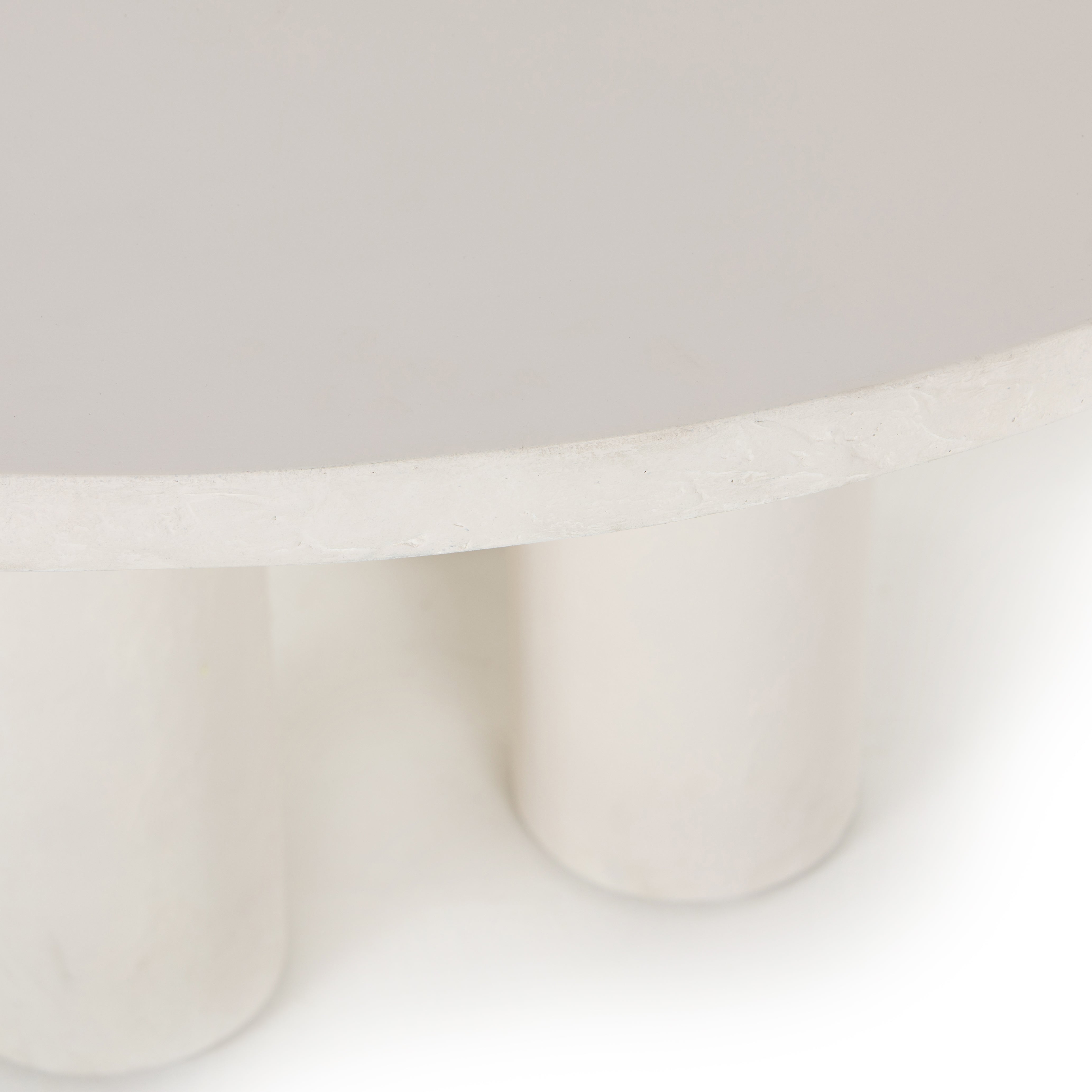 This Parra Dining Table - Plaster Molded Concrete is made from plaster-molded concrete with a cylindrical pillar-style base tapering slightly to support a smooth, white-finished tabletop. We love the texture and brightness this brings to any dining room or kitchen area.   Overall Dimensions: 59.75"w x 59.75"d x 30.00"h