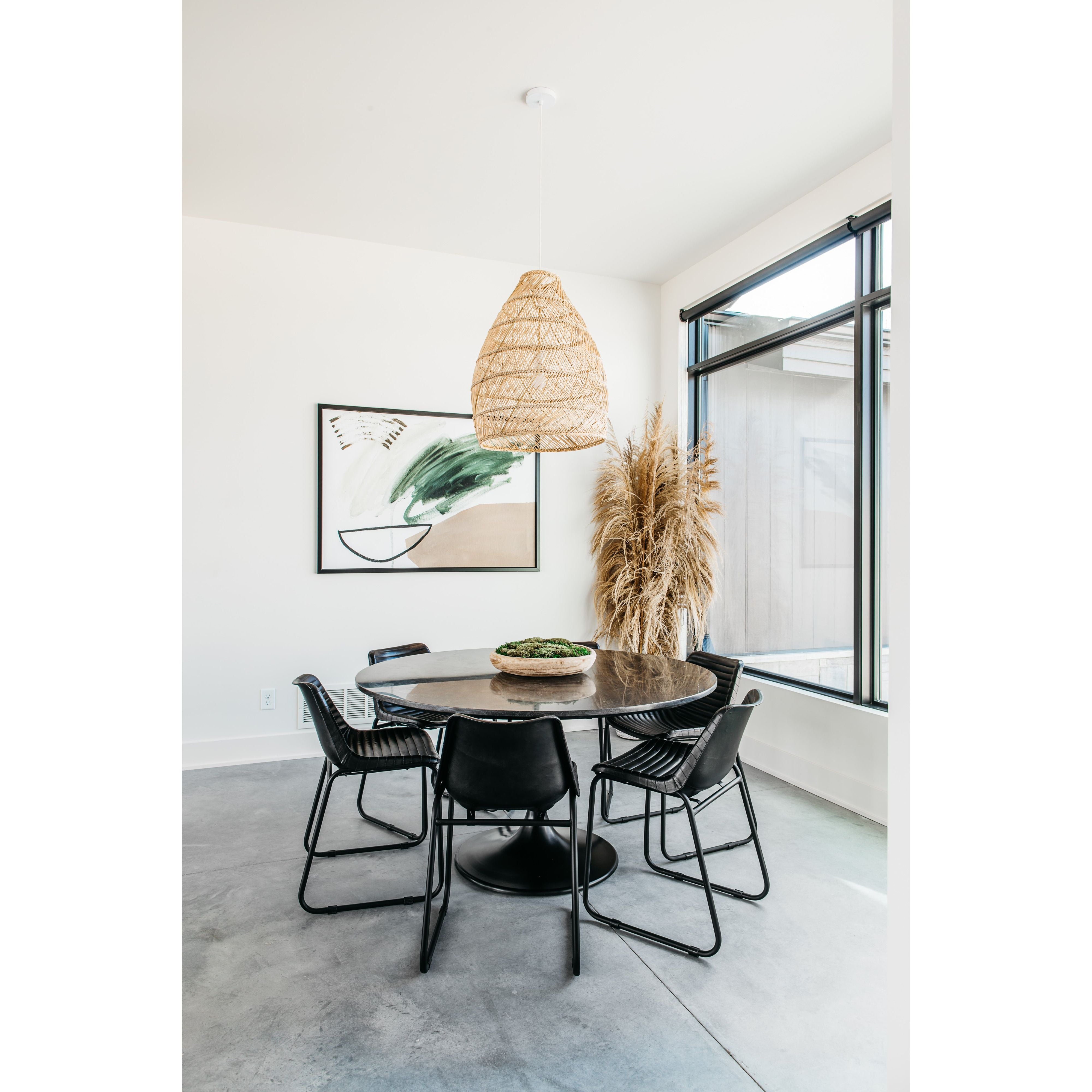 Classic tulip shaping is recast with a rustic black iron finish topped with a solid bluestone table top. This cute bistro style dining table is perfectly sized for a cozy breakfast nook.  Size: 55.00"w x 55.00"d x 29.50"h